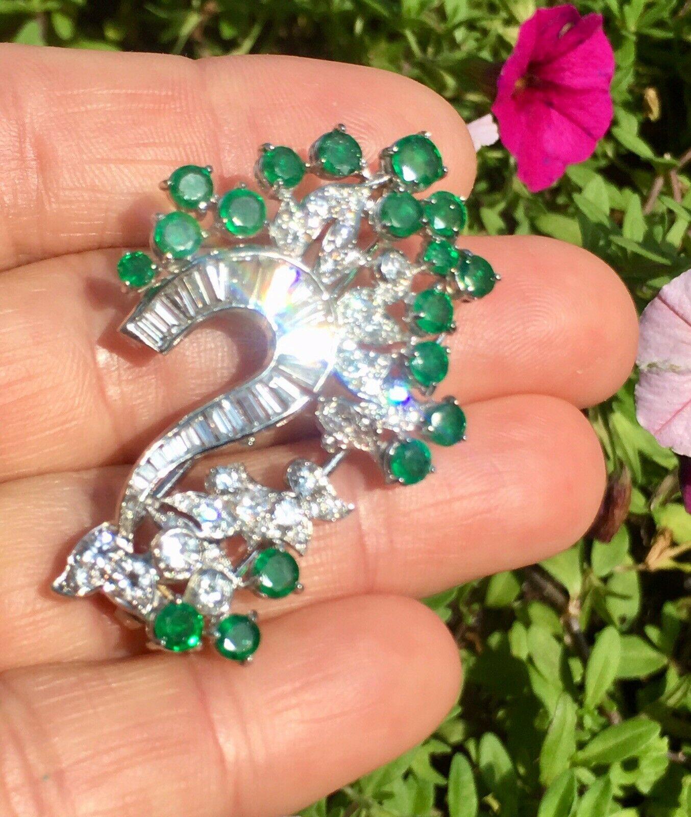 This stunning 1950s retro diamond and emerald pendant is set in platinum with 2.00 carats of beautiful G VS baguette and round brilliant diamonds. It is furthest with approximately 1.25 carats of lovely colorful sparkling emeralds.  A sizable