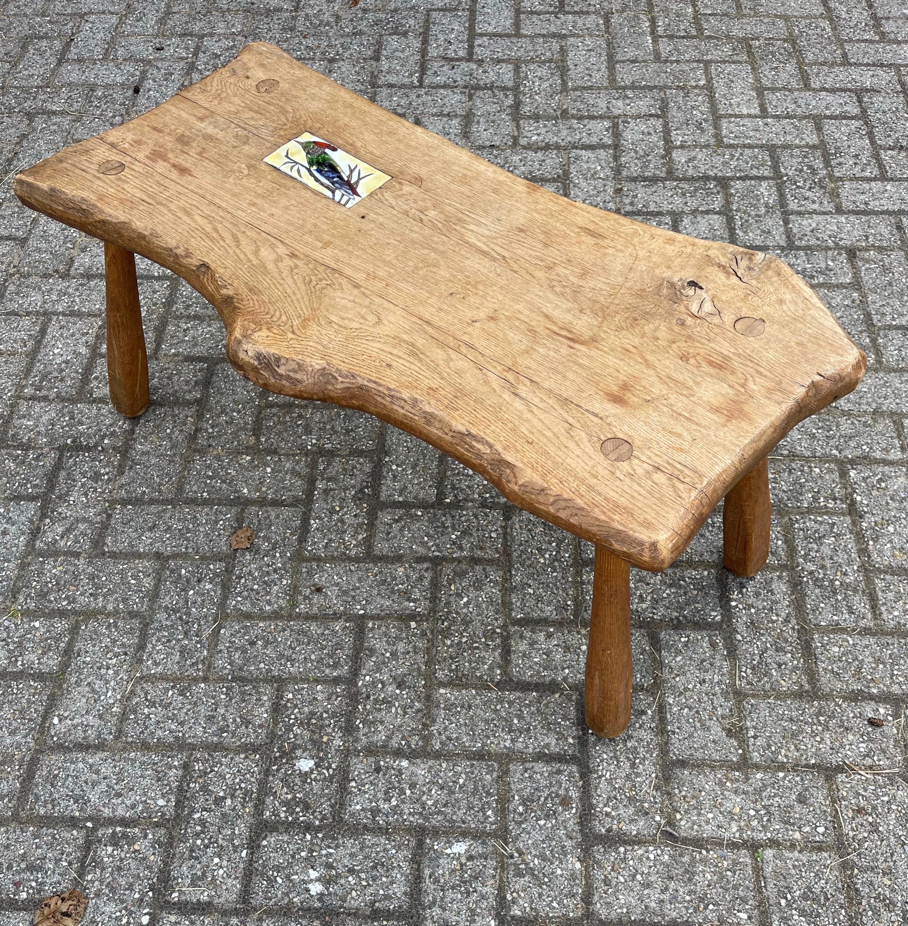 Unique and great looking, natural materials table.

This wonderful coffee table from circa 1950 is all handcrafted in the rustic style and this gives it its 19th century look and feel. With the inlaid glazed tile depicting a hand-painted European