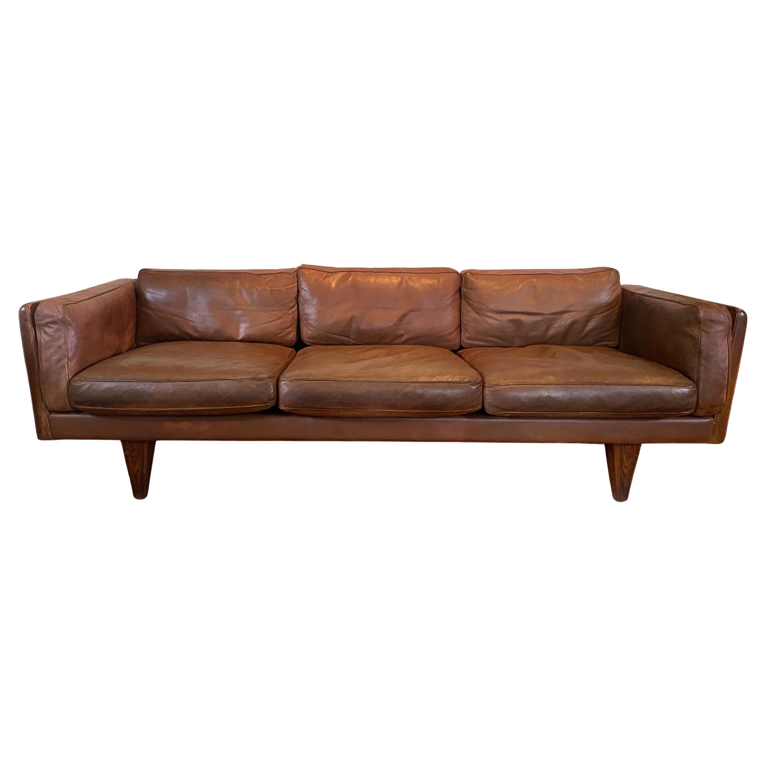 This rare and highly collectible Model V11 three-seater sofa is a signature piece by Illum Wikkelsø, one of Denmark’s most celebrated mid-century modern designers. Originally crafted in 1965 in collaboration with master cabinetmaker Holger