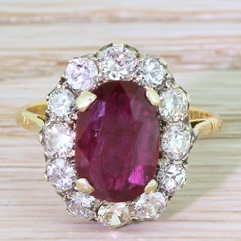 A fabulously crafted coronet cluster. The centrepiece is a fine, deep red natural ruby that shows no evidence of heating or treatment. Surrounding the ruby are twelve brilliant cut diamonds, the whiteness of which emphasises the richness of the