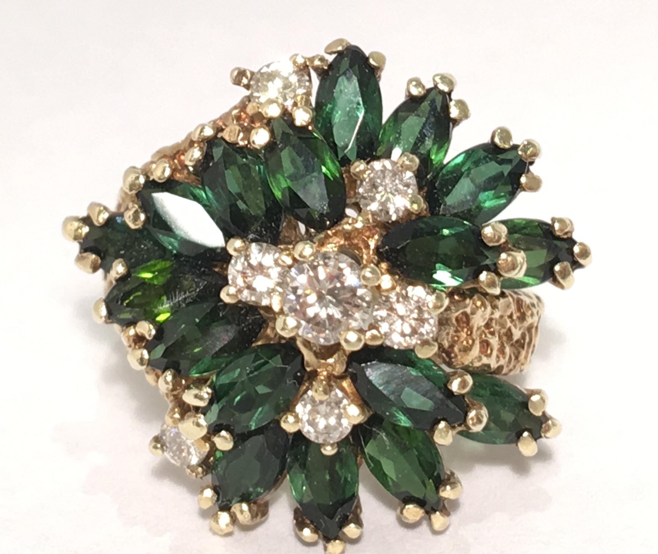 Richly textured, 14 karat yellow gold, Brutalist design, mid century 1970s estate cocktail ring features 17 prong set, marquise-cut dark green tourmalines and 7 prong set, round brilliant diamonds.

Tourmalines measure 6 mm x 3.12 mm x 2.11 mm and