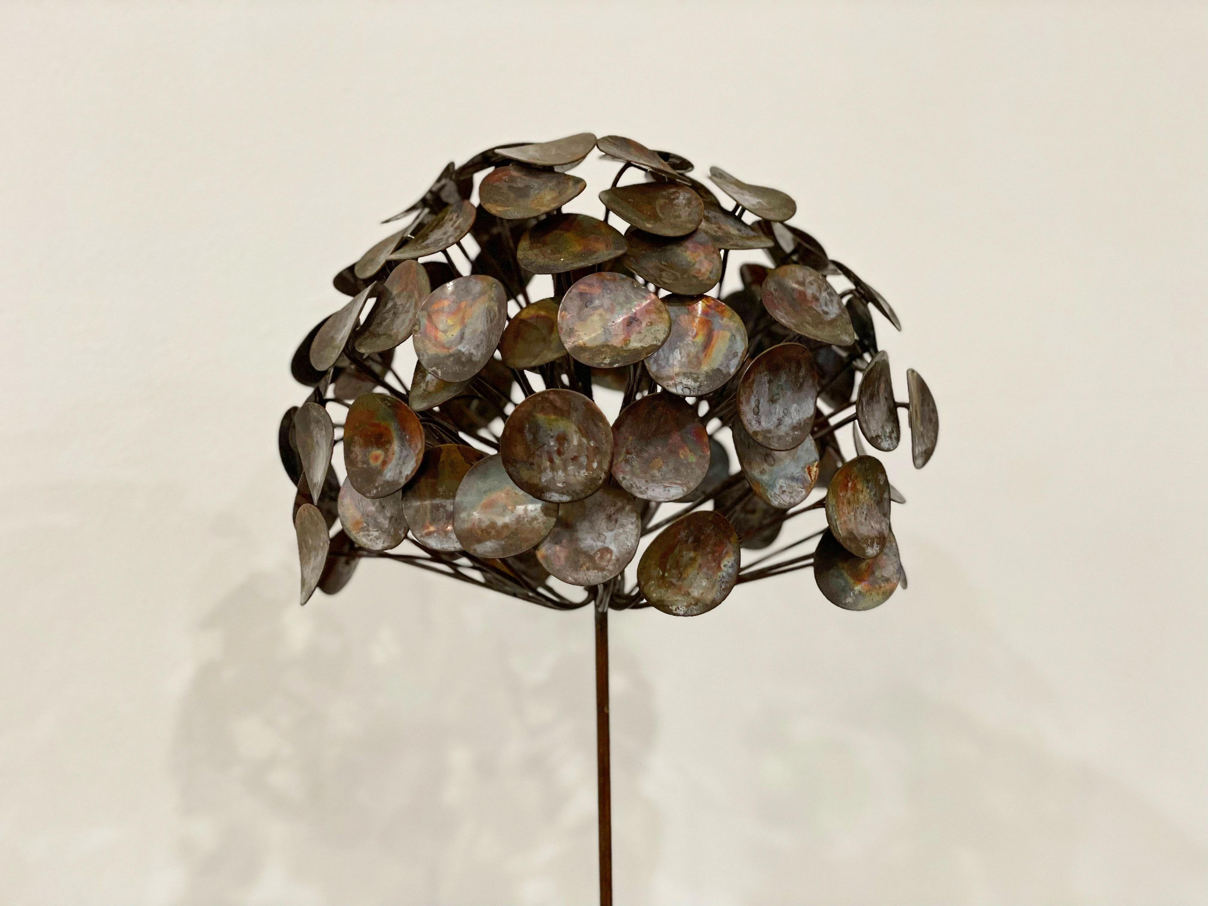 Mid century brutalist style mixed metal flower sculpture, after Curtis Jere. Unsigned. Patinated metals mounted on a black lacquered wood block.
Excellent condition with no flaws of note. Ready for installation.

Measures: W10