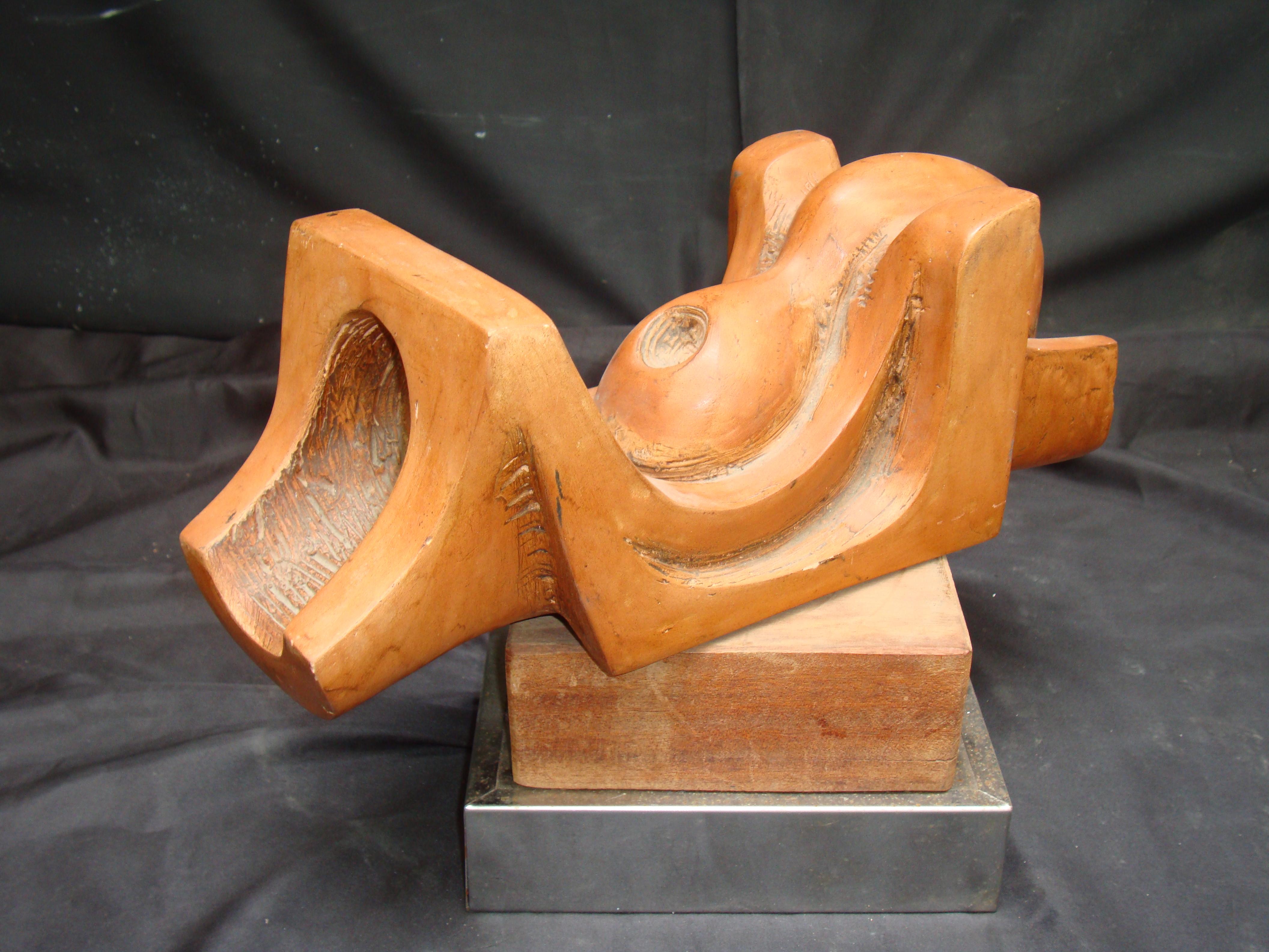 A mid-20th century abstract terracotta sculpture on wooden base, very articulated composition and shape. Signed T. Assi.