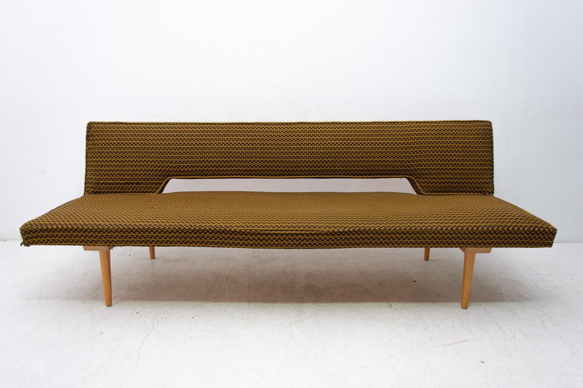 Midcentury adjustable sofa-bench designed by the Czech famous designer Miroslav Navrátil in the 1960s. Made in Czechoslovakia. It features were attractive and simple design. Material: fabric, beechwood. It´s a typical example of Czechoslovak design