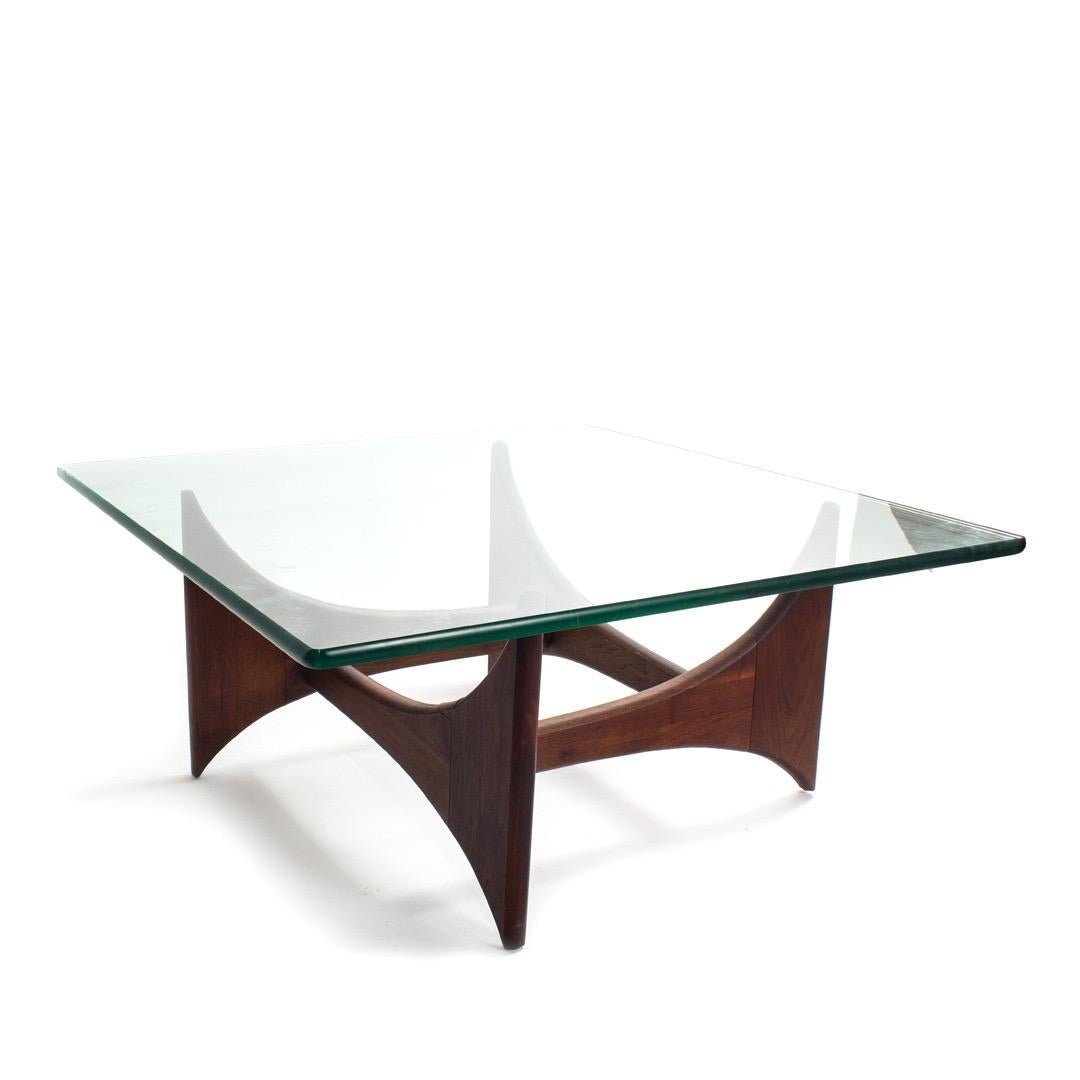 A walnut base coffee table with square glass top by Adrian Pearsall. USA, circa 1950.

Dimensions of 36 inches square by 16 inches high.