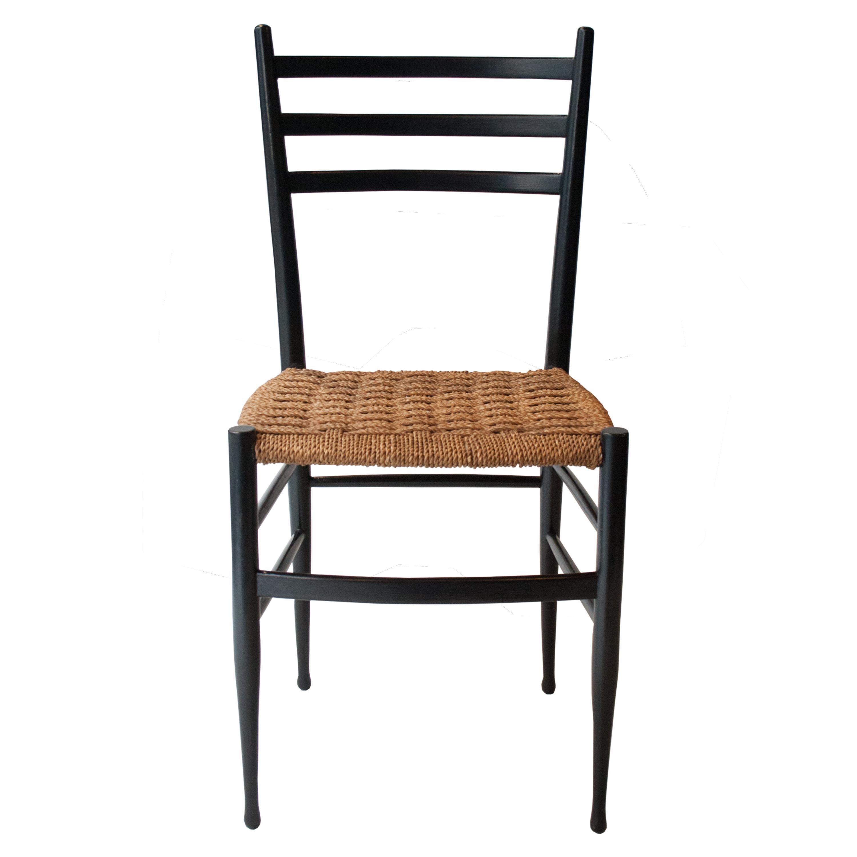 Set of 4 Italian chairs from the 1950s Gio Ponti style. Black lacquered solid wood structure with seats in natural fiber.