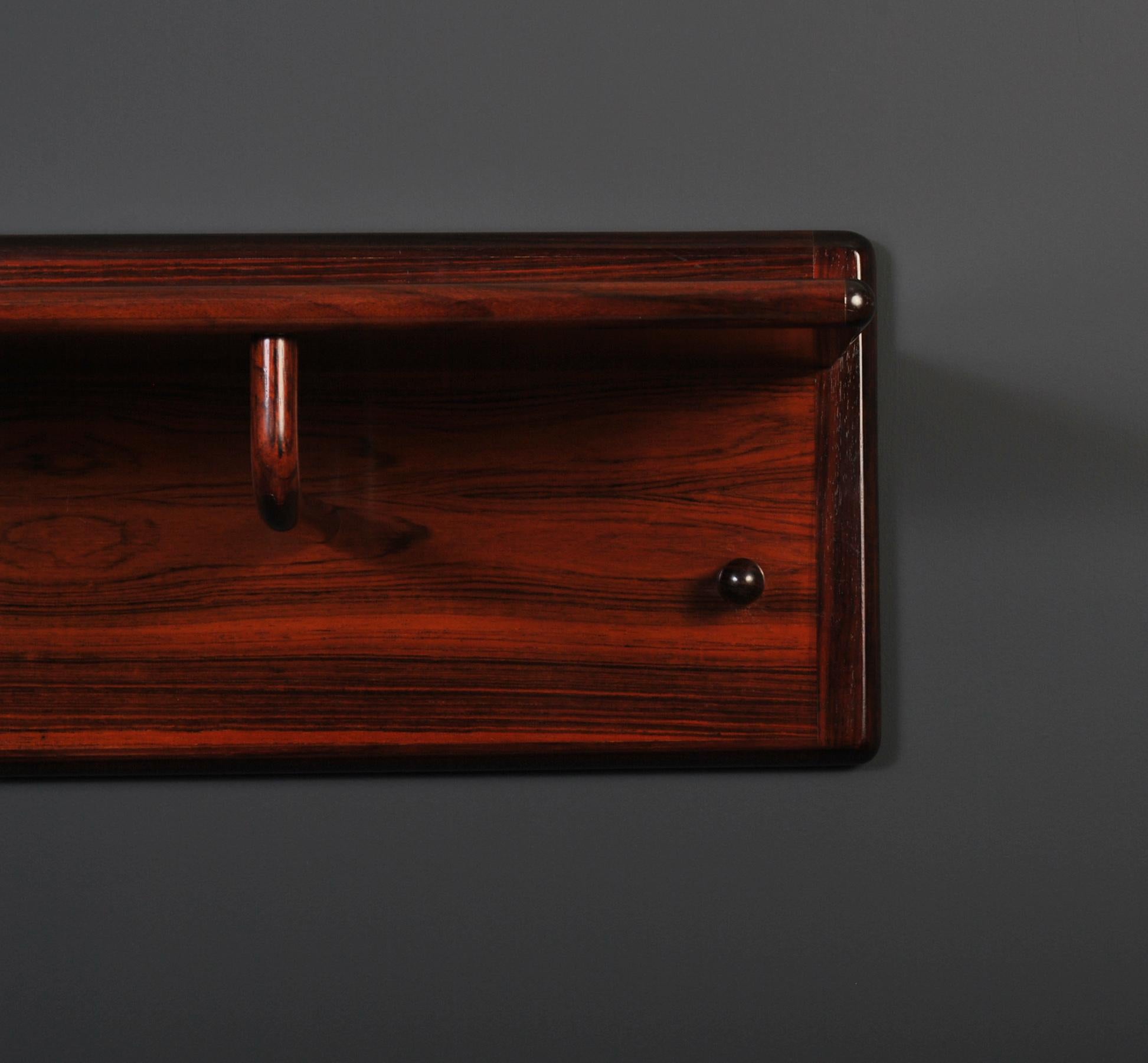 A very rare piece by Aksel Kjersgaard for Vildbjerg. Large wall mounted coat and hat rack. Superb design in rosewood.