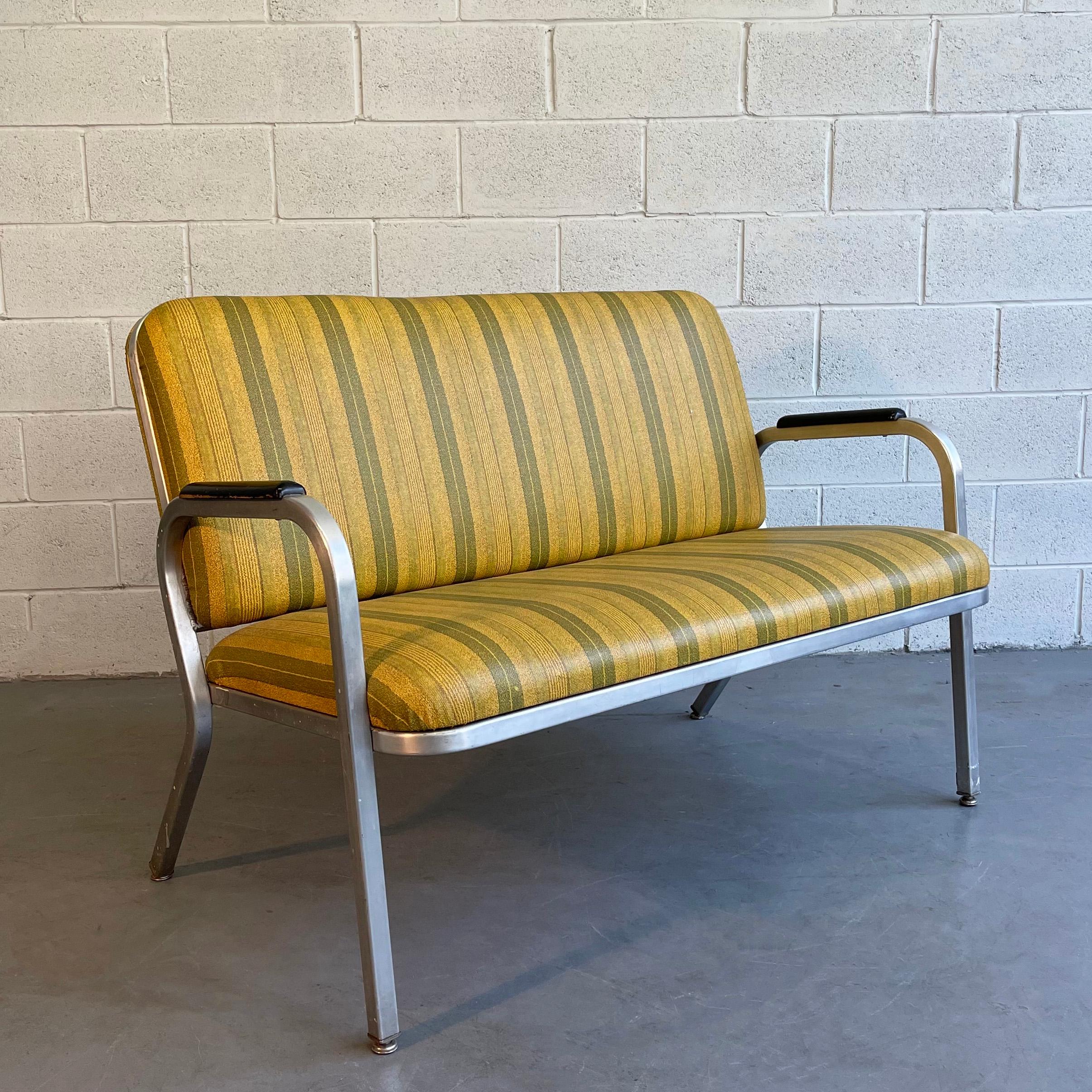 Midcentury, machine-age loveseat sofa by GoodForm, The General Fireproofing Co. features a streamlined aluminum frame with striped vinyl upholstery and painted wood armrests.