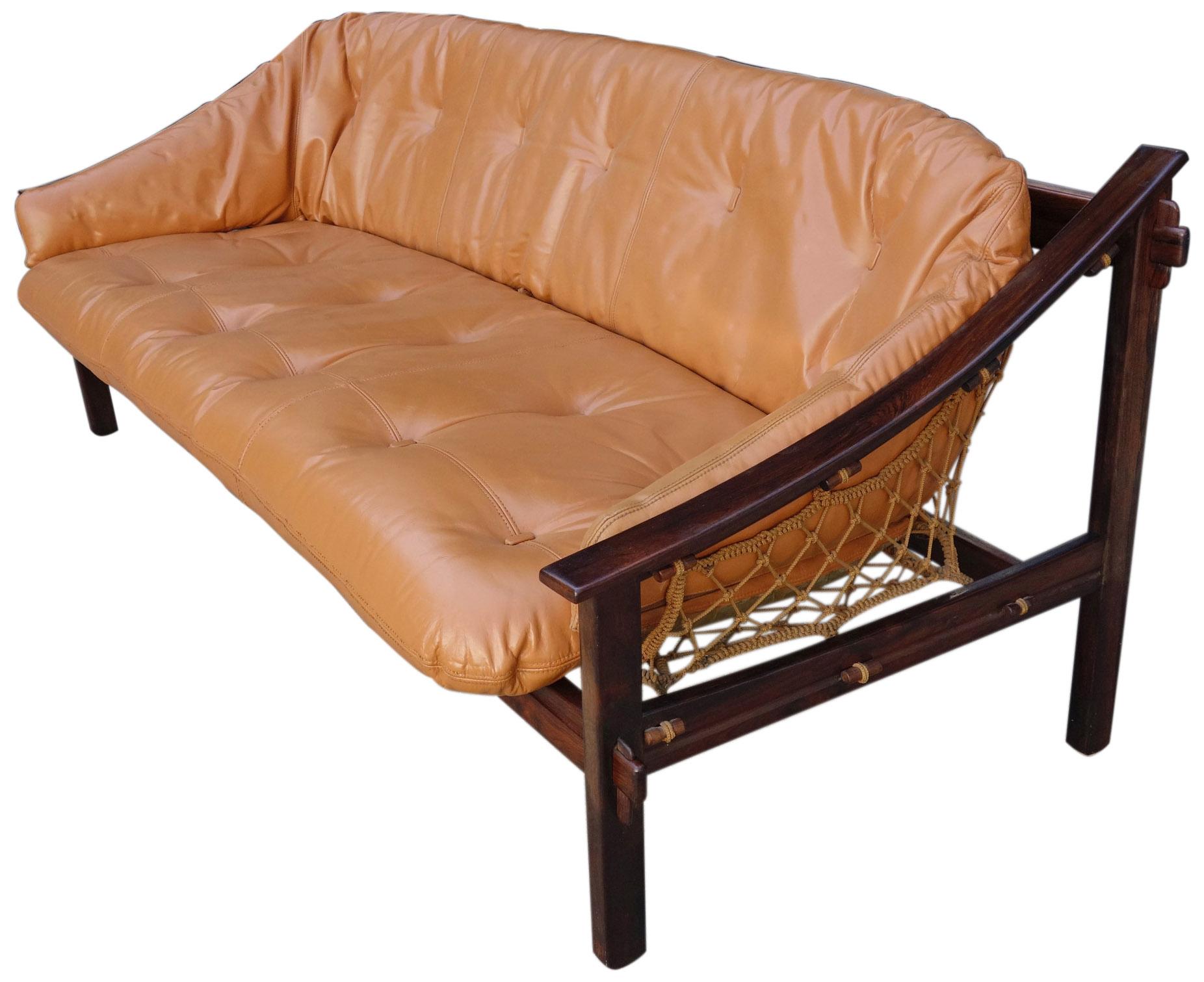 Pure Brazilian midcentury. Featuring a solid Brazilian rosewood frame and netted rope inspired by local fisherman. This sofa has a sleek design that look spectacular from any angle. This item is in original condition with the leather having been