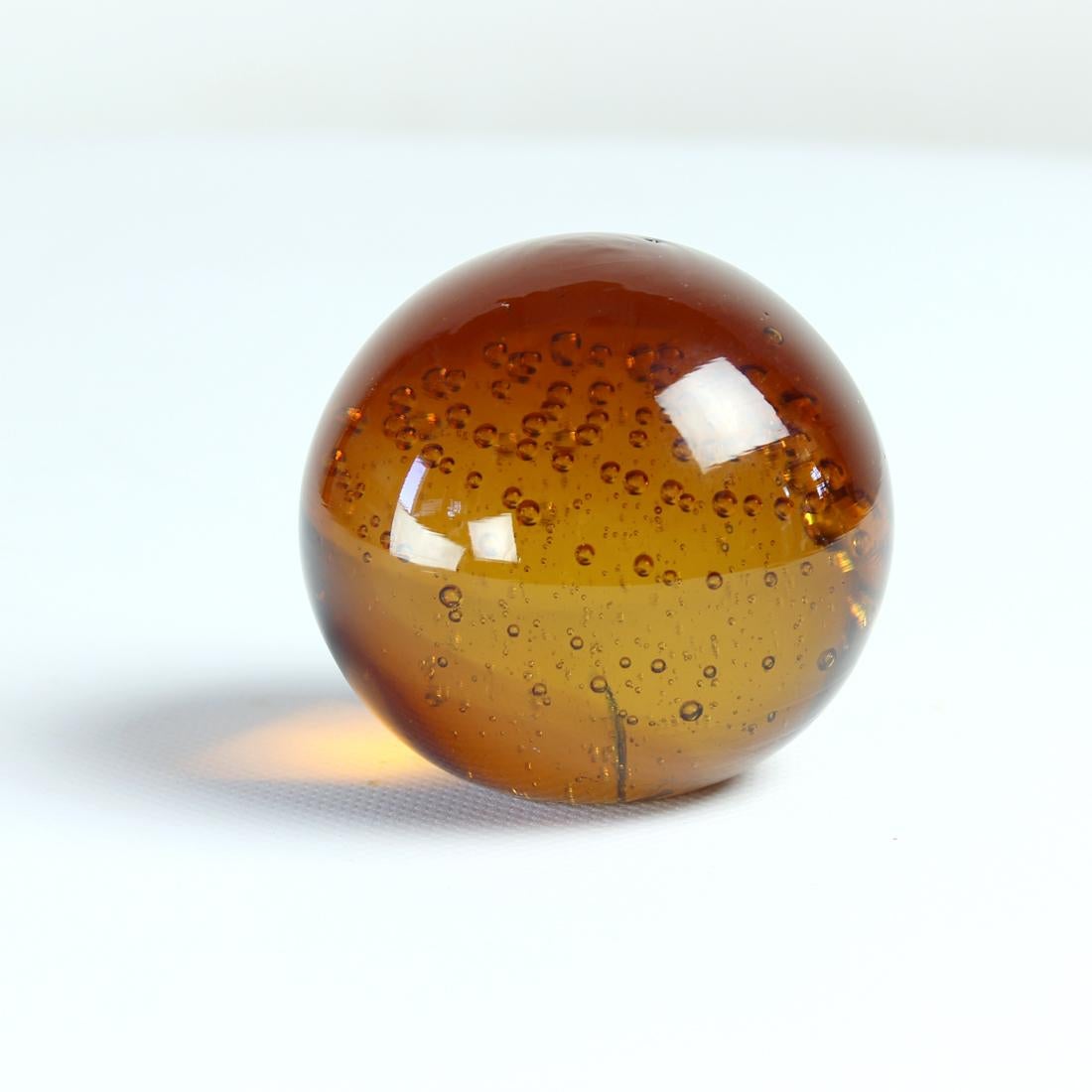 Unique vintage desk paperweight. Produced by Borske Sklo in 1960s. Original amber color of the glass which is rare to see and find. The glass has the bubbles inside which were hand placed in the hot glass when it was made. The design is trully