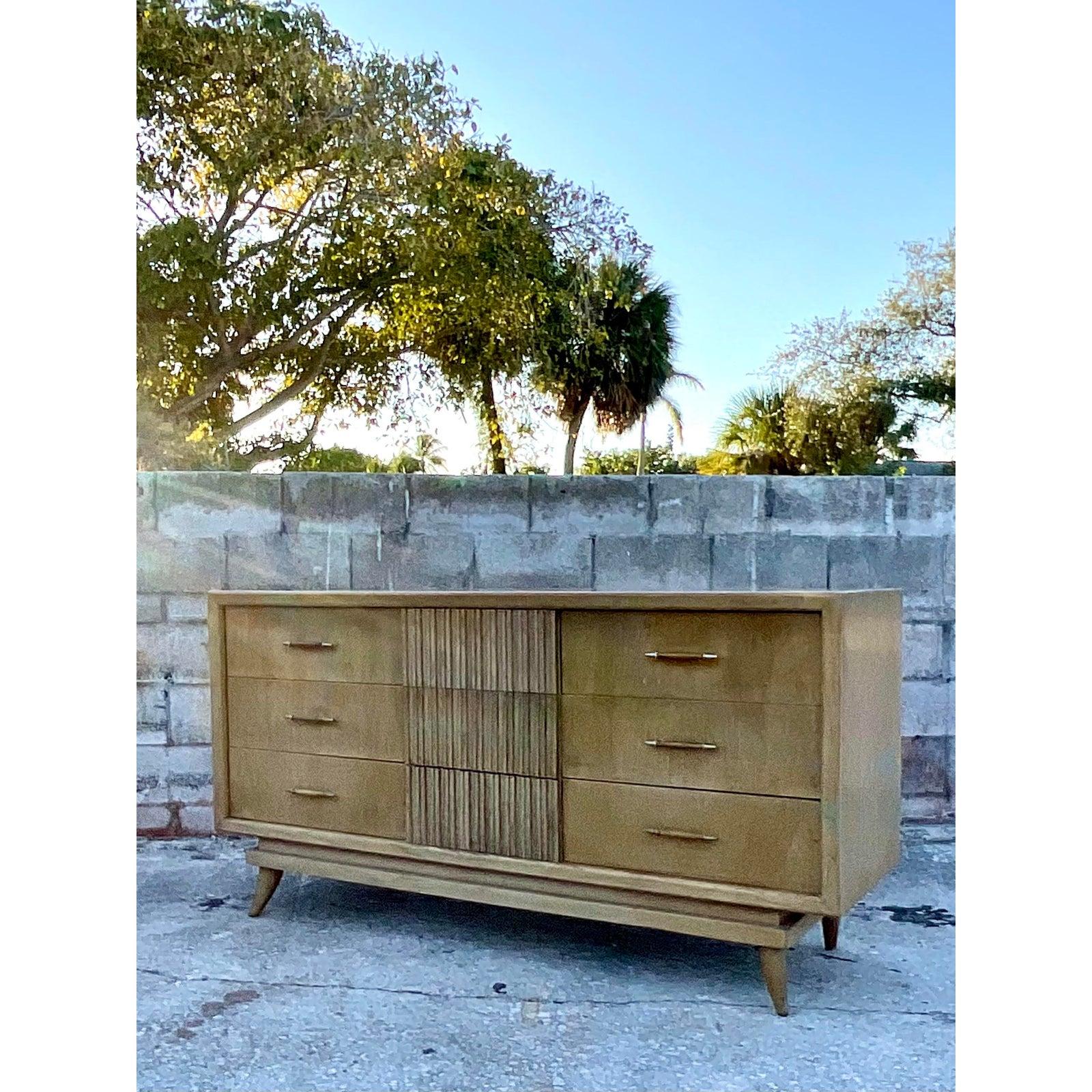 Fantastic vintage mid-century American of Martinsville dresser. Chic rib drawer fronts in the center row. Rests on a pierced apron brace. Matching nightstands also available. Acquired from a Miami estate.