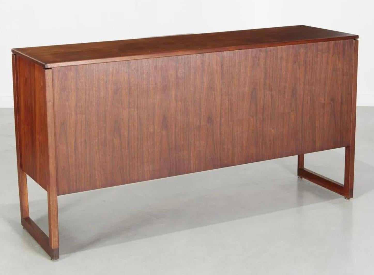 Beautiful American studio craft Mid-Century Modern long black walnut 8-drawer dresser credenza with all solid Brass curved pull handles. High end Construction with Metal Drawer slides. Great design good vintage condition with stunning walnut grain.