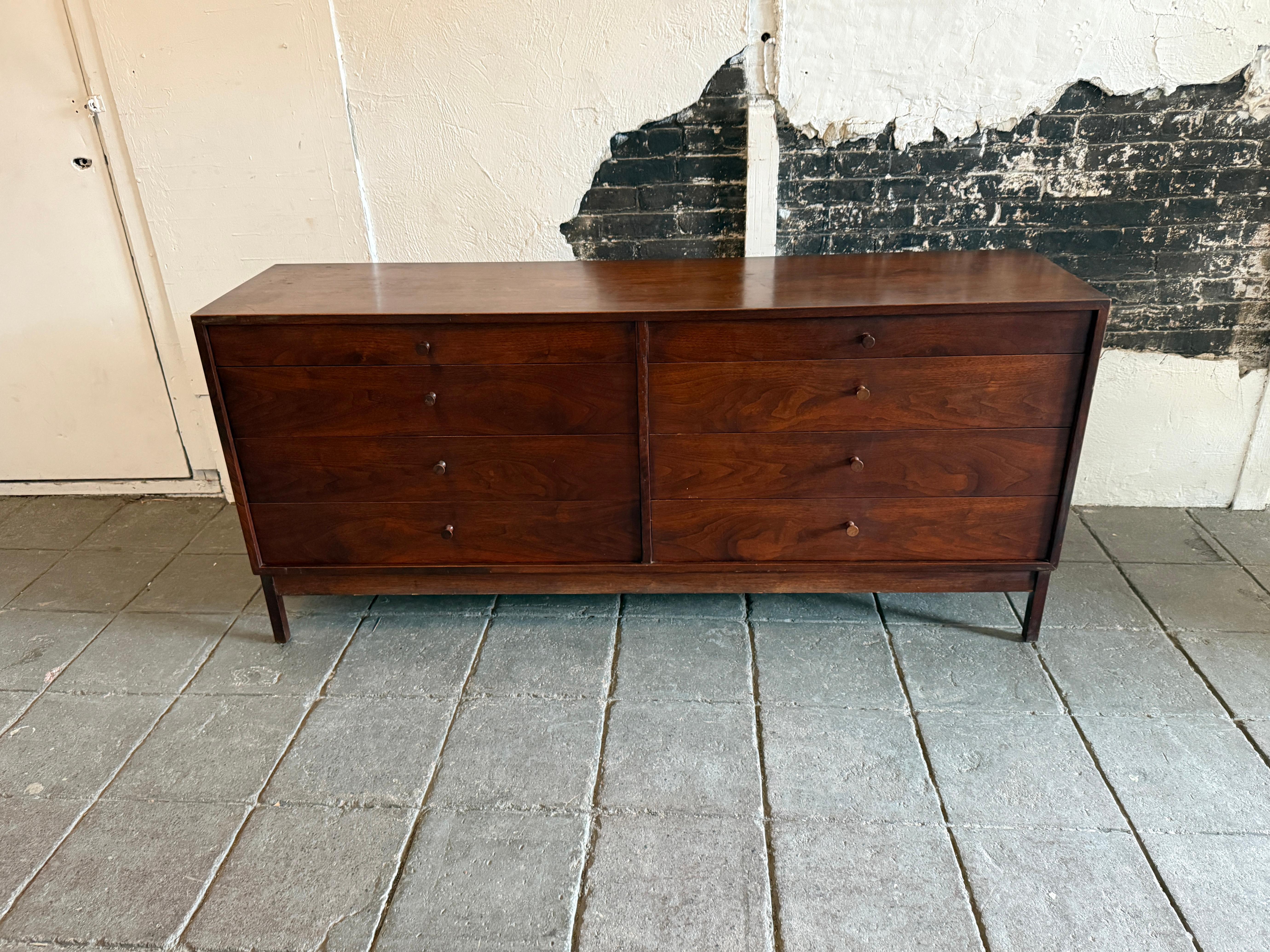 Beautiful American studio craft Mid-Century Modern long black walnut 8-drawer dresser credenza with all solid carved walnut pull handles. Great design good vintage condition with stunning walnut grain. Rare studio craft dresser by Richard