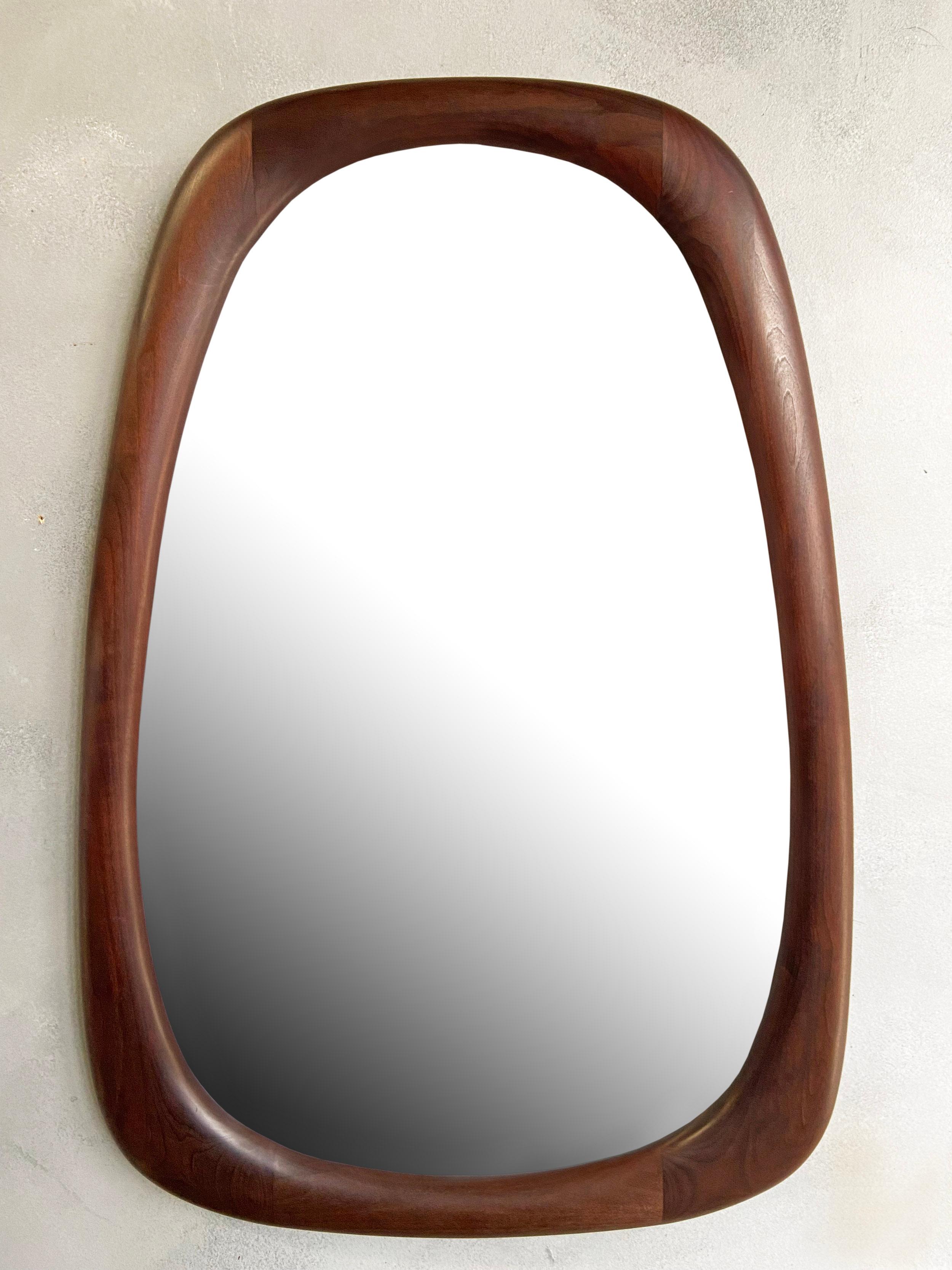For your consideration is this beautifully sculpted mirror by Dean Santner. Master craftsman Dean Santner designs are part of the American Modern Craft movement along side Wendell Castle, Nakashima, Phillip Powell to name a few

This hand sculpted