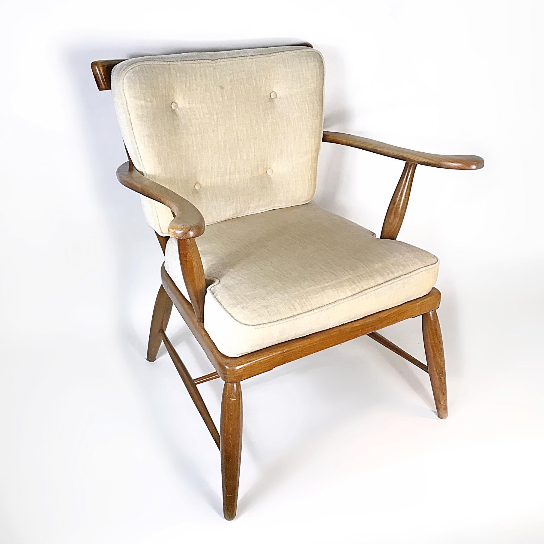 Beautiful walnut wood armchair designed by Anna-Lülja Praun in 1950s. The chair has a solid walnut wood frame with original cushions. The chair is in a very good original condition with minor wear due to age and usage. Very comfortable