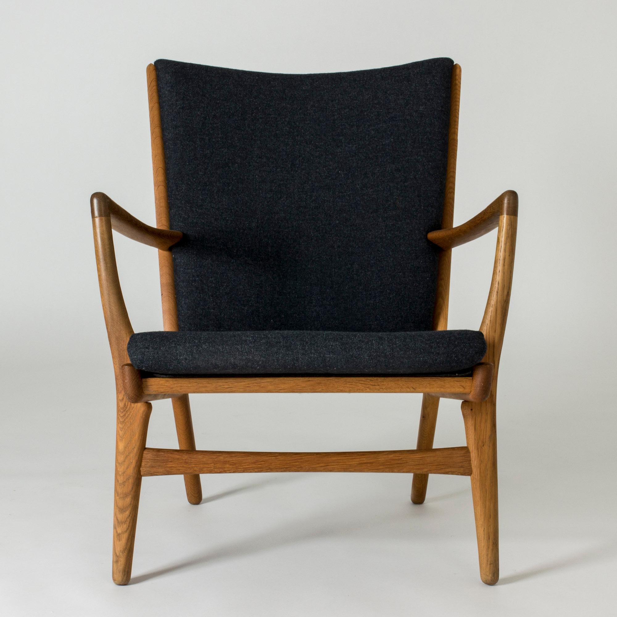 Cool “AP 16” lounge chair by Hans J. Wegner. Made from oak and upholstered with dark grey wool fabric. Bold, graphic lines.