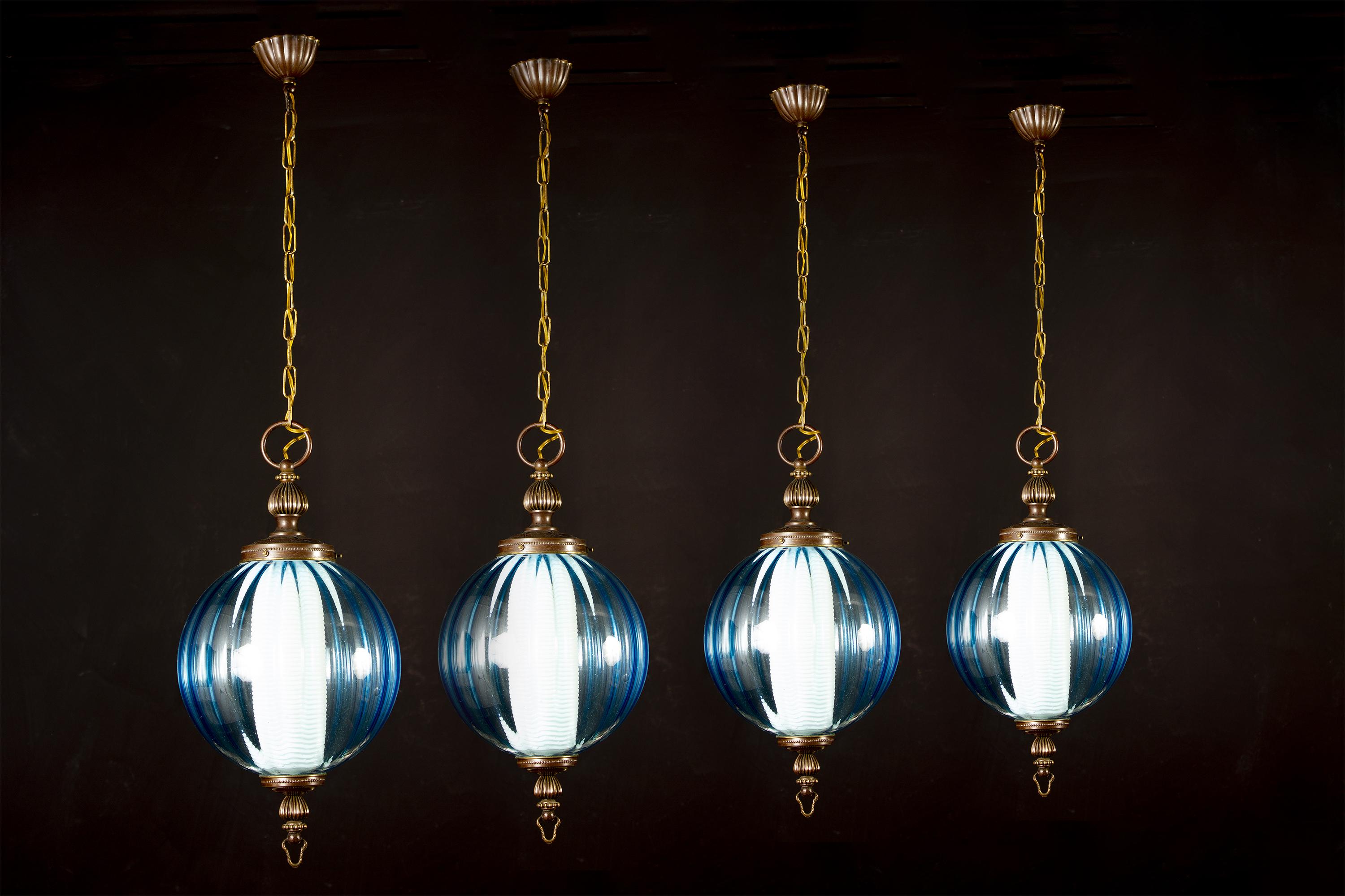 A rare set of four midcentury aquamarine color Murano glass atmosphere lights or lanterns.
Inside each with a E 27 light bulb covered by a refined ribbed opaline glass, creating a fabulous light effect.
Attributed to Luigi Caccia Dominioni.
Each