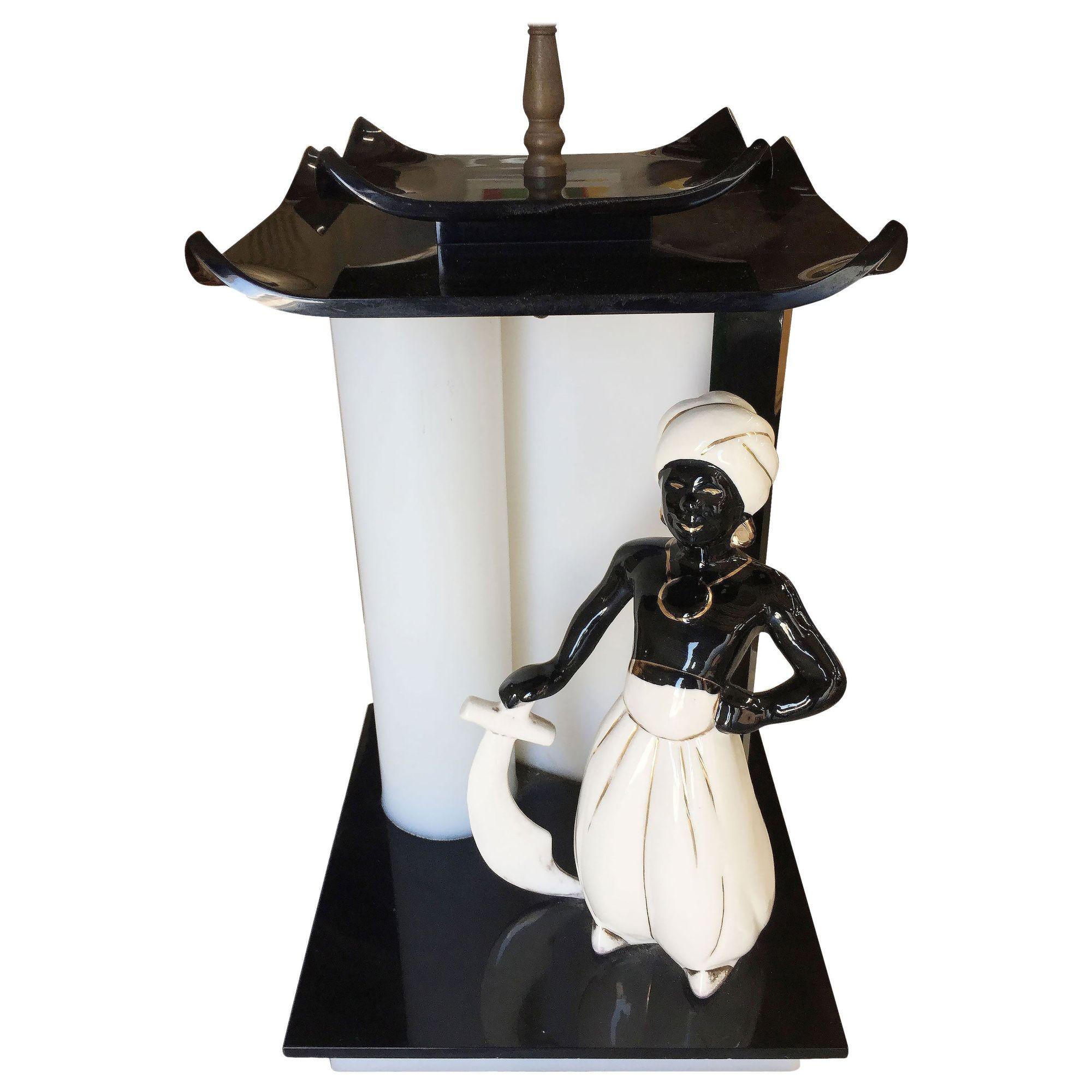 Mid-century Arabian 1950 inspired Lucite lamp by Moss featuring a handcrafted acrylic lamp with decorative ceramic China man statue in the middle.
