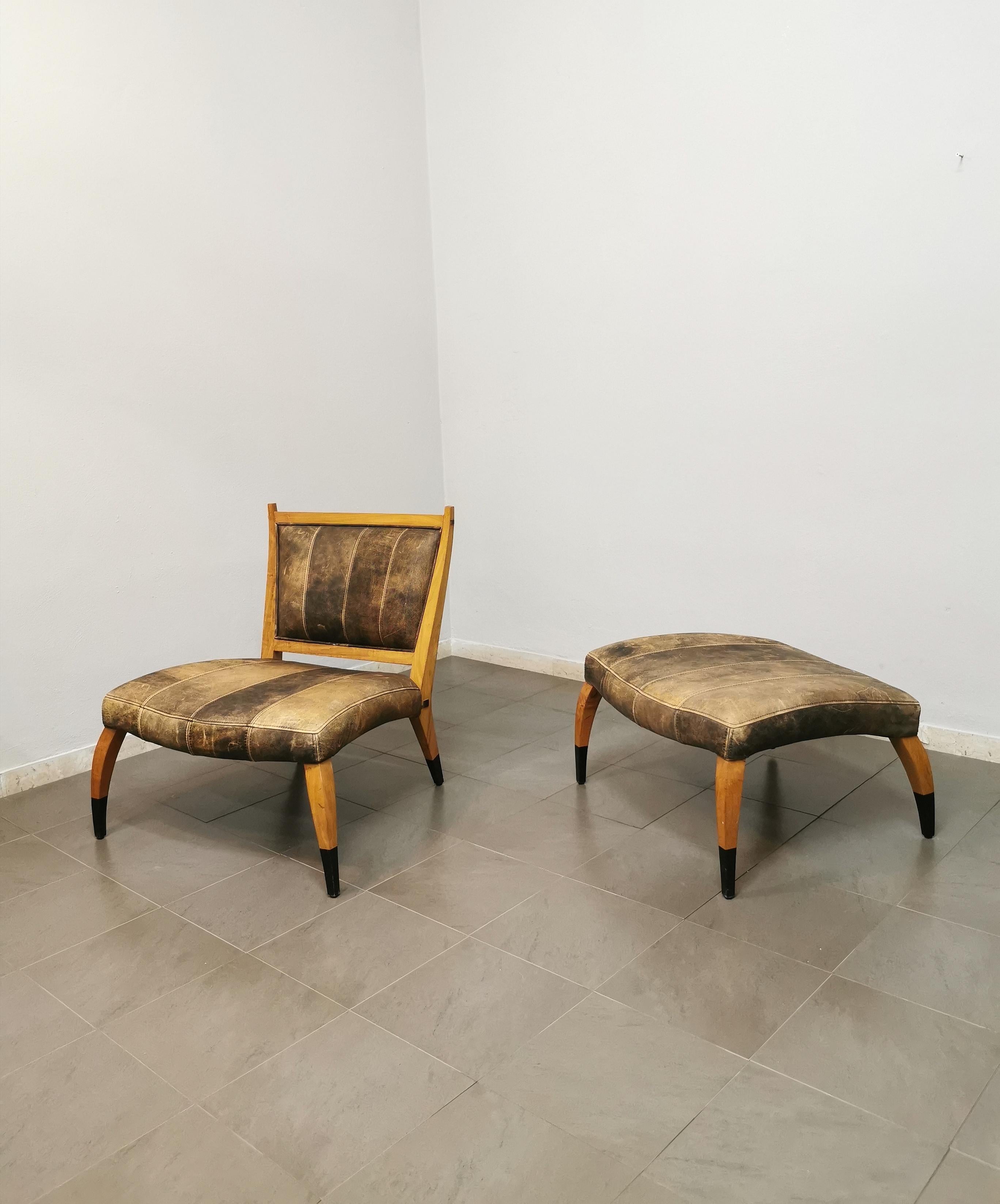 Armchair and footrest with particular shapes by an unknown designer, produced in the 1960s. The set has a curved wood structure with seat and back in aged leather.