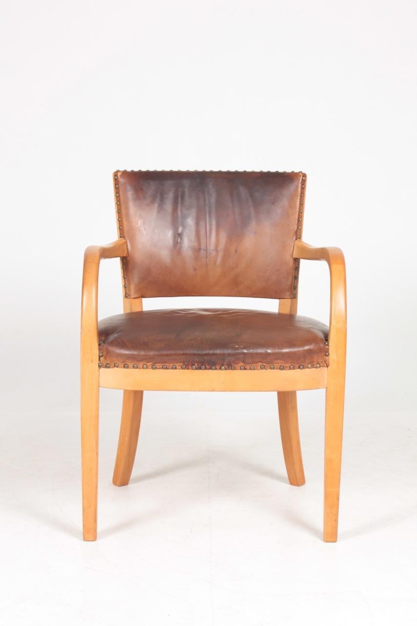 Armchair in patinated leather designed and made by Fritz Hansen in 1940s. Original condition.
