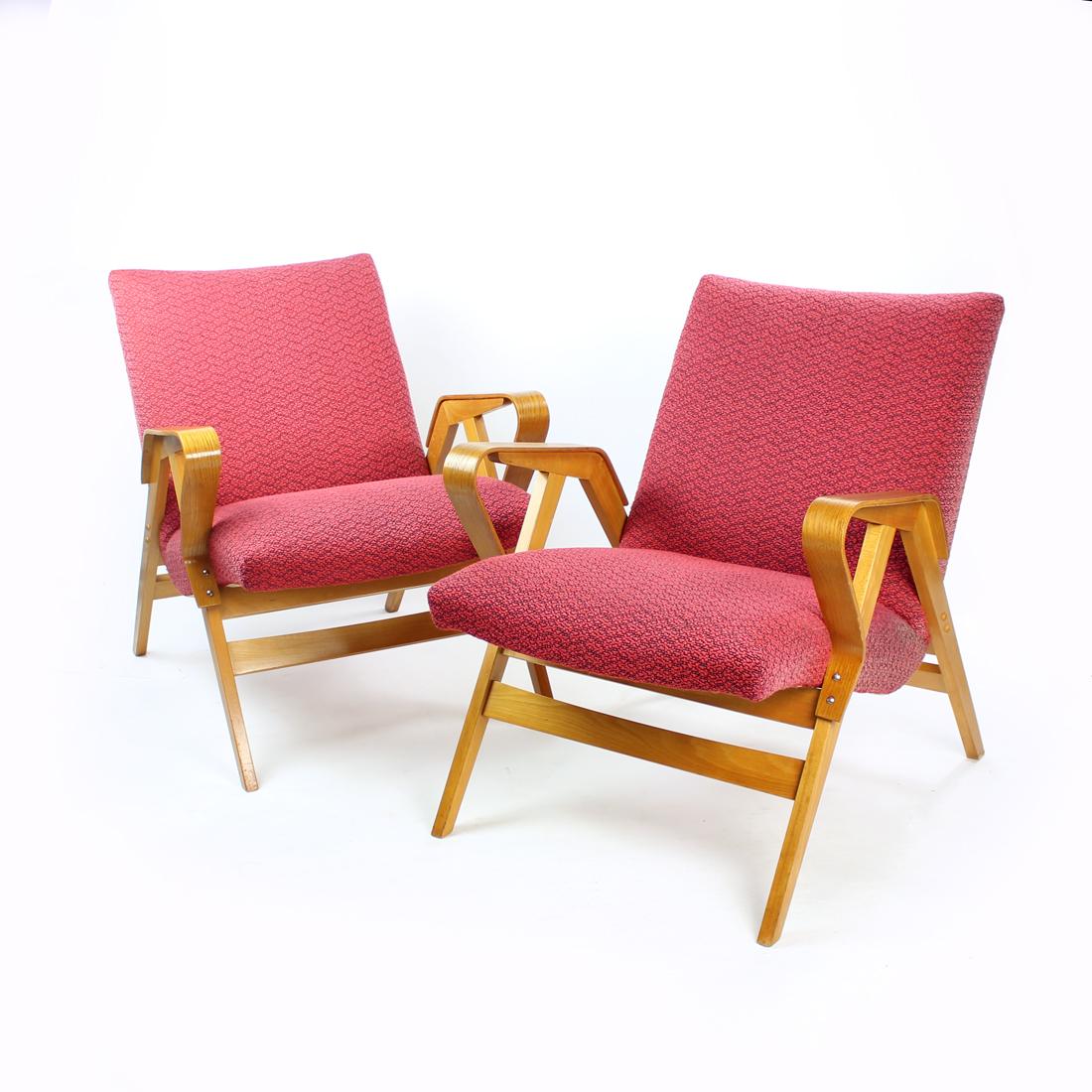 Beautiful armchair produced by Tatra company in Czechoslovakia in 1960s. The original label is still attached. The chairs are a well known and comfortable model produced in Czechoslovakia. Designed on a oak wood construction with bent plywood