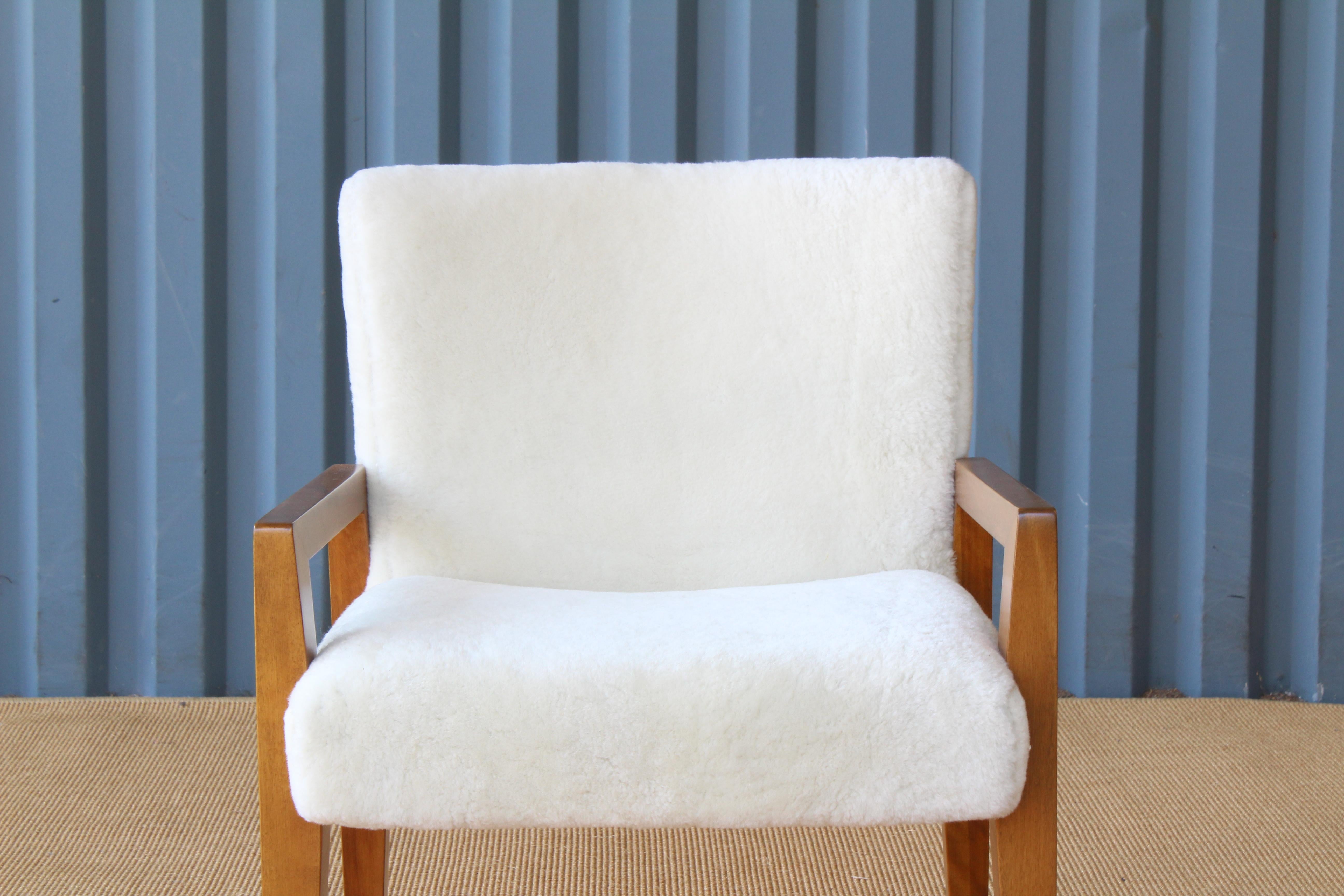 1950s midcentury armchair with a birchwood frame and new shearling upholstery.