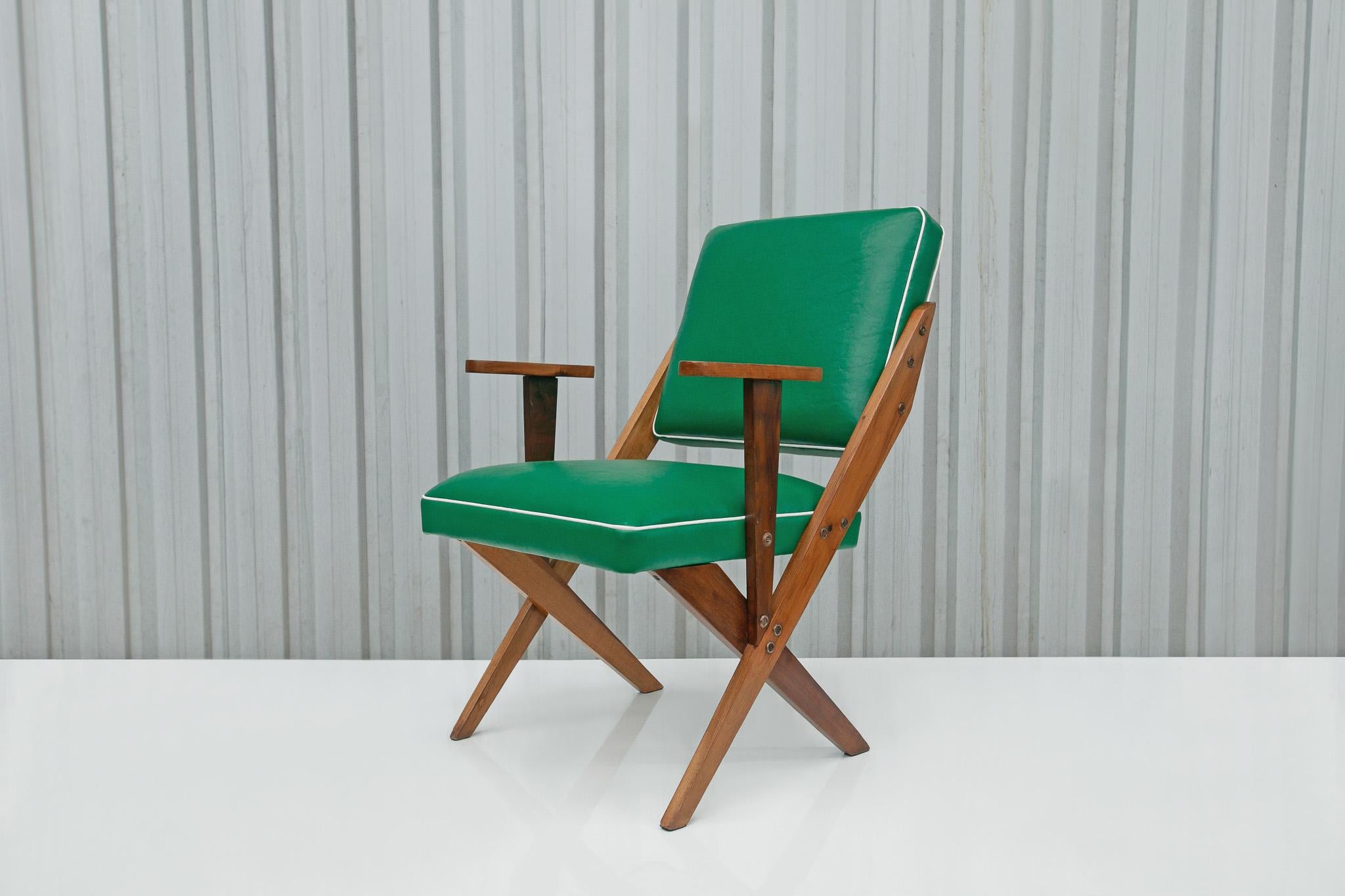 Available today, this gorgeous and super comfortable Mid-century Armchair in Wood & Green Faux Leather designed by Jose Zanine Caldas in the fifties is gorgeous!

This one-of-a-kind armchair consists of a hardwood structure with re-upholstered