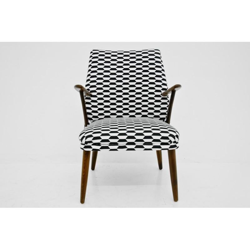 This midcentury modern armchair comes from Denmark from 1960s. Made of walnut wood. 
This item is after renovation of the wood and changing the upholstery for the new one in black&white pattern.