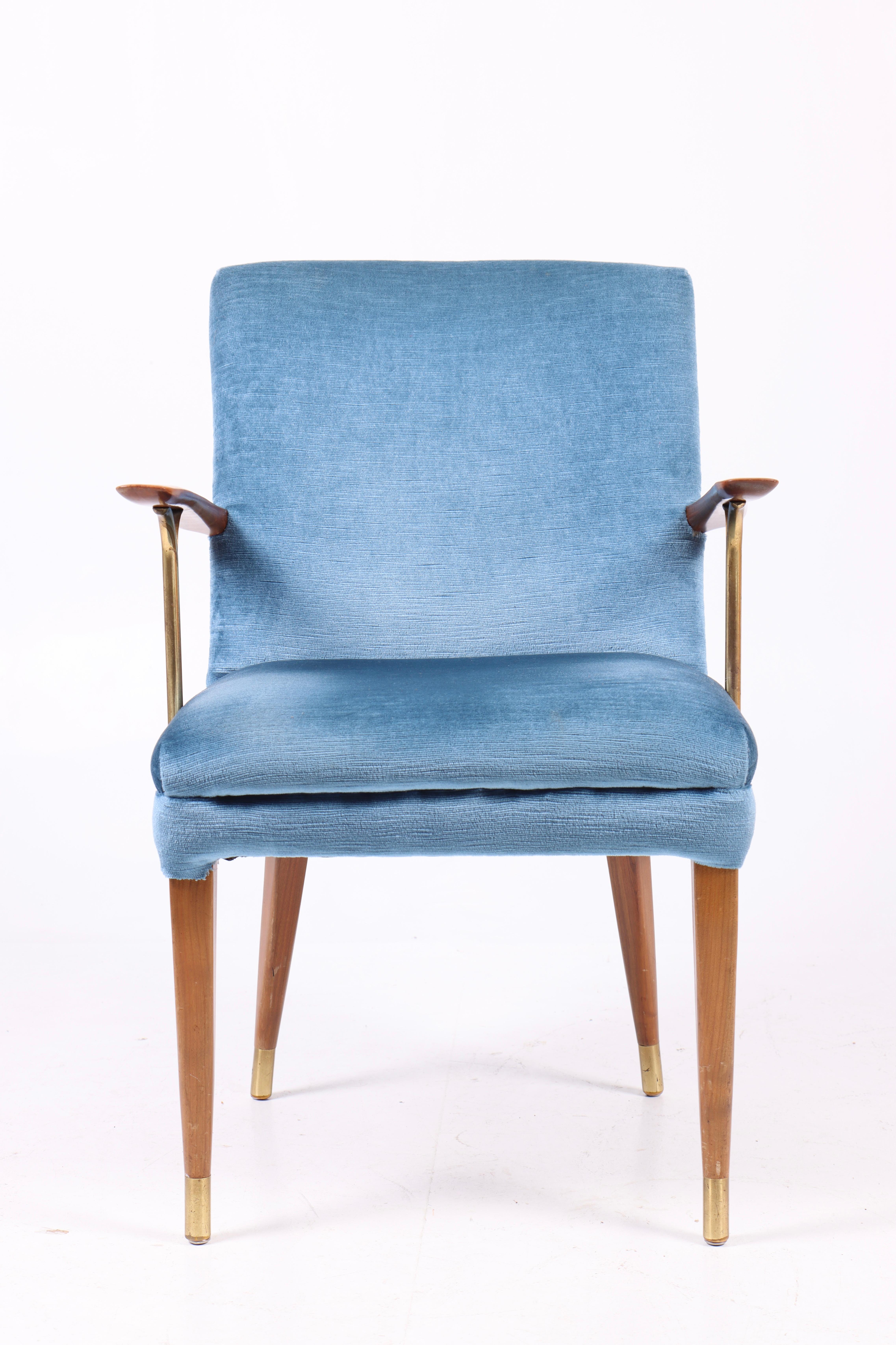 Armchair in fabric with brass details. Designed and made in Sweden 1950s.