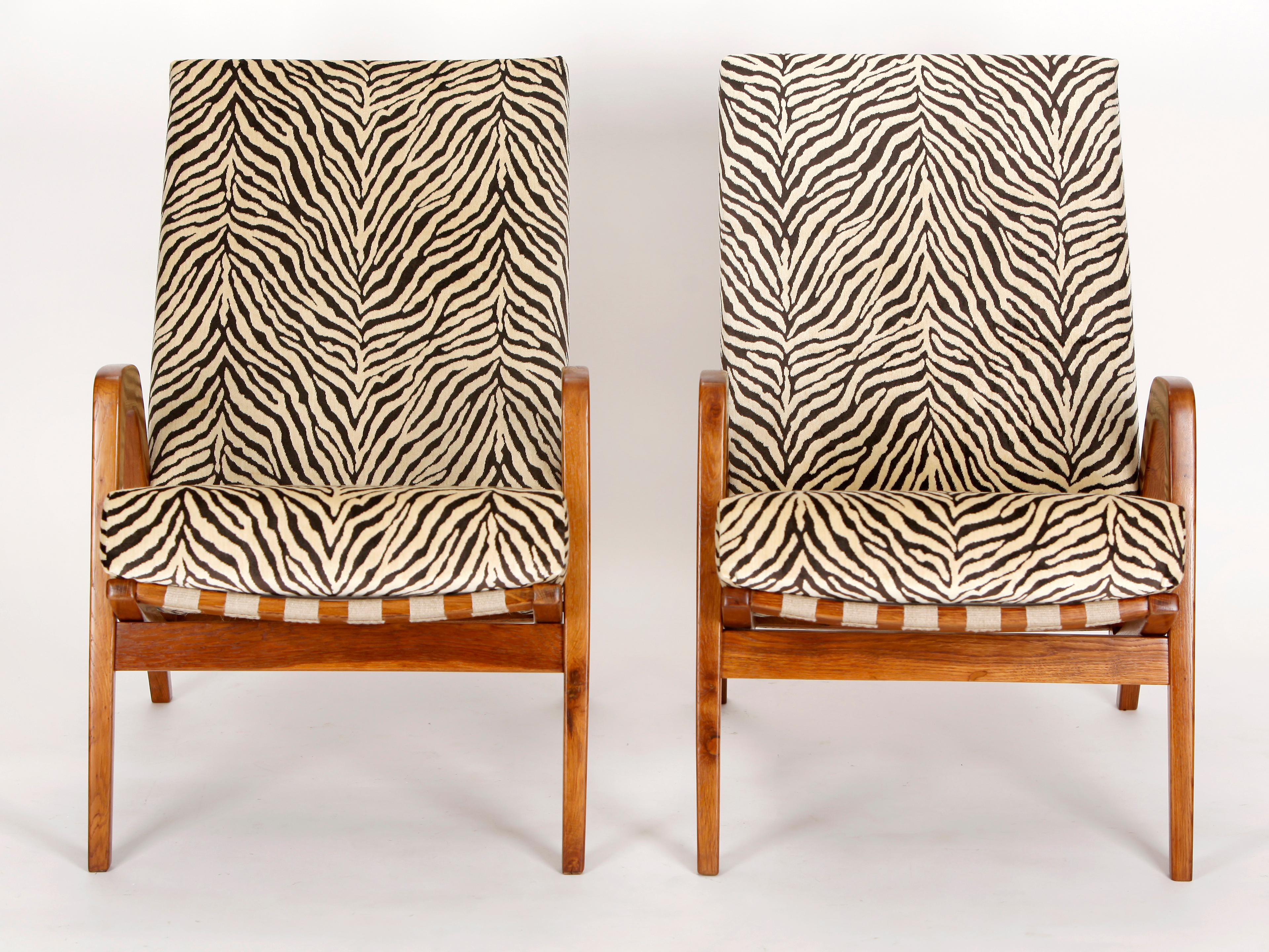 These two armchairs was made in the former Czechoslovakia in the 1950s. The hemp straps have been renewed and the wooden parts repainted. The cushions have a coconut fiber core wrapped in sheep wool. The cover is made from zebra print velvet by the