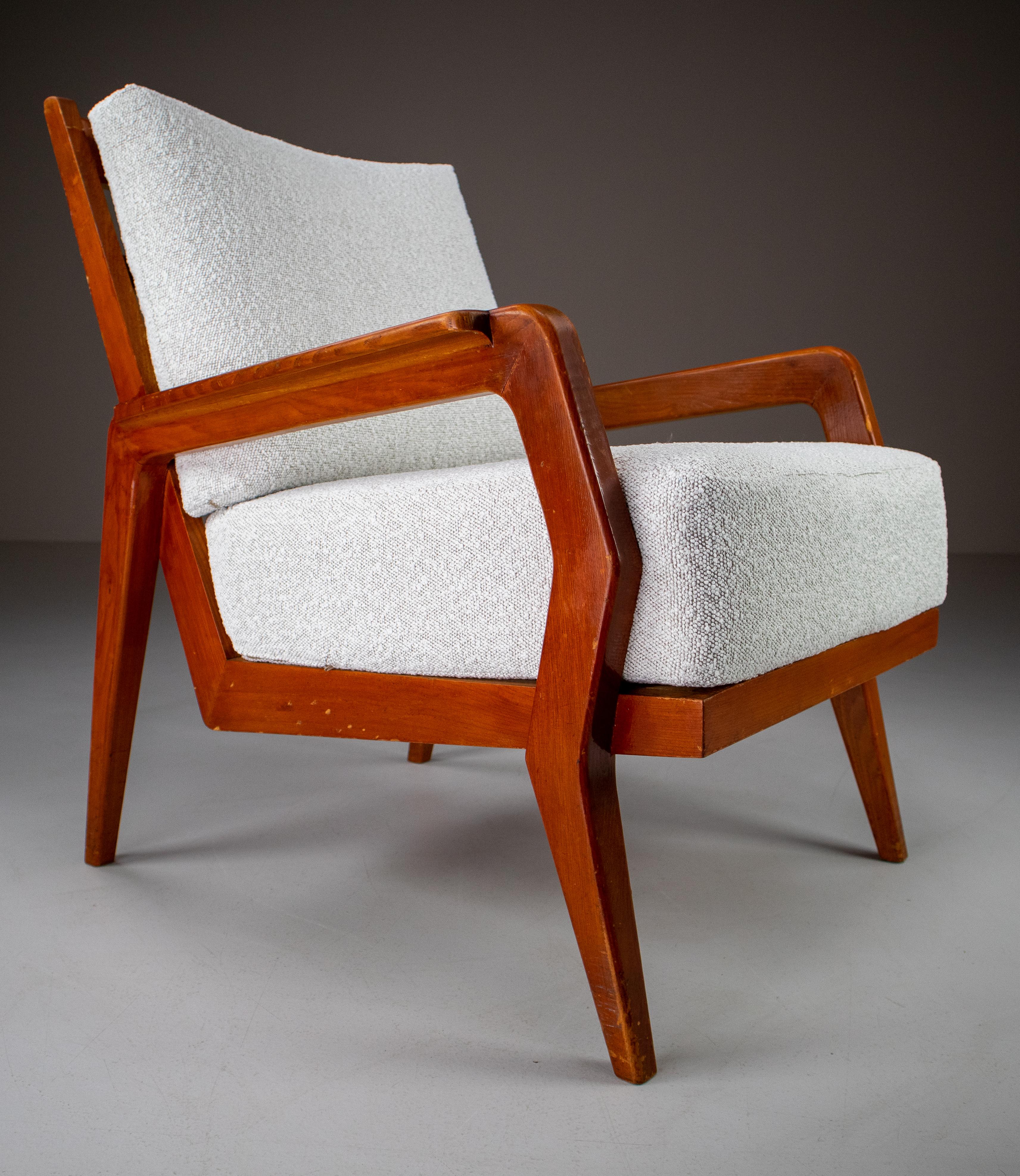 Pair of two original midcentury armchairs or lounge chairs manufactured and designed in France 1950s. Made of solid Ash and professionally reupholstered in reupholstered in bouclé fabric. These armchairs would make an eye-catching addition to any