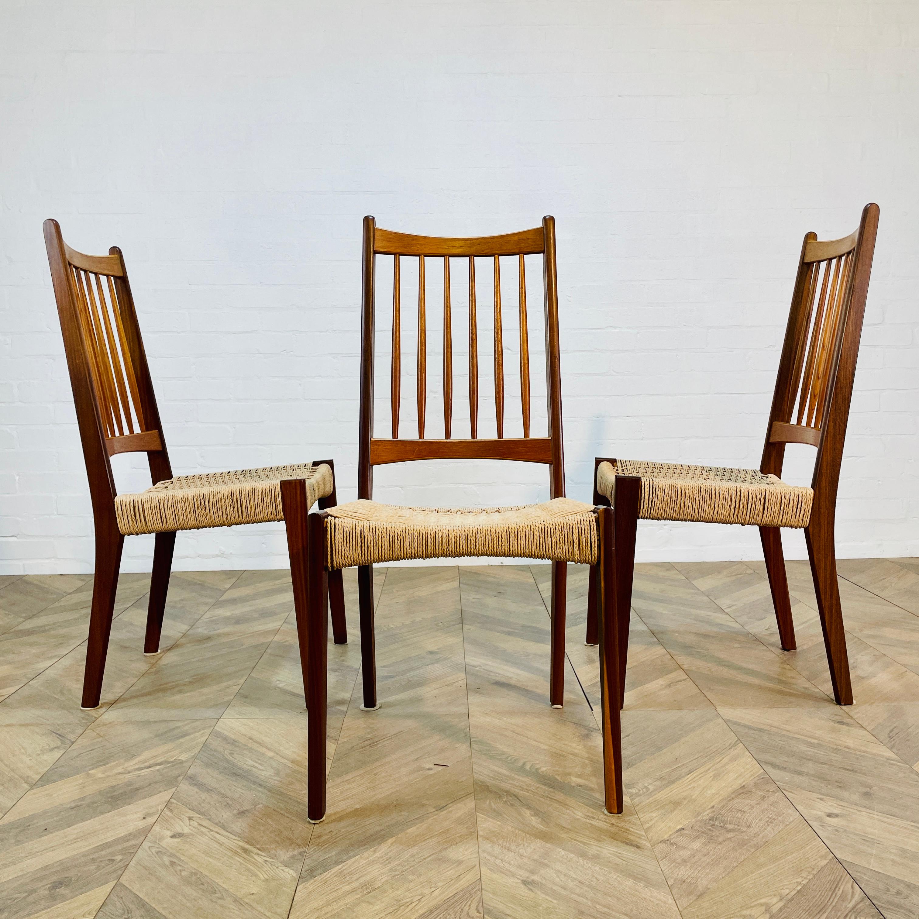 Set of 3 Beautiful Dining Chairs, Designed by Arne Hovmand Olsen for Mogens Kold in Denmark. Circa 1960s.

Teak framed with handwoven paper cord seating (not original). The cord is flexible so shapes to each person. The gently curved backrest offers