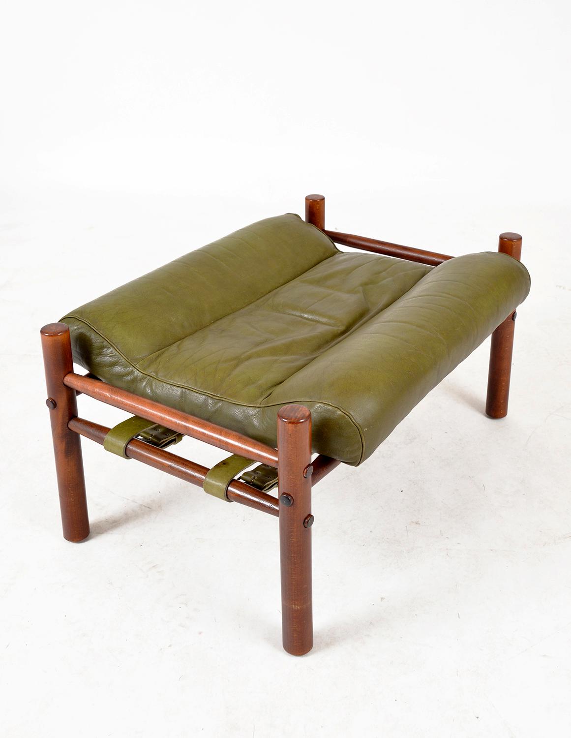 A beautiful example of a 1960s “Inca” ottoman by Arne Norell in stained beech and original green leather, manufactured by Möbel AB Arne Norell in Aneby, Sweden. The footstool is in wonderful condition with very little wear considering its age, and