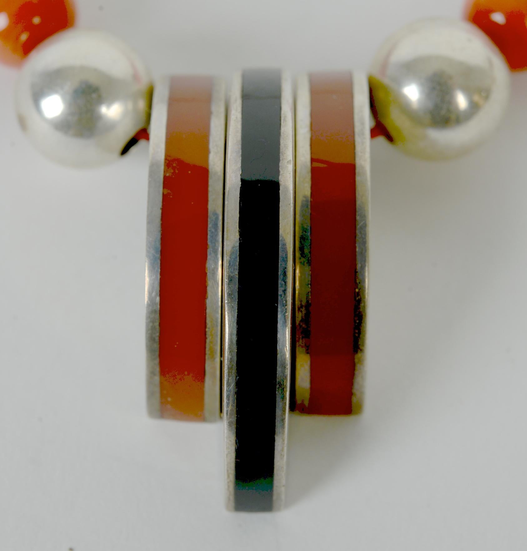 Mid Century Art Deco Style Sterling Silver and Bakelite Necklace. A great example of Art Deco jewelry that is marked by its geometry and symmetry. The 3 piece pendant is bakelite in a silver sandwich. The necklace is made of Bakelite coral colored