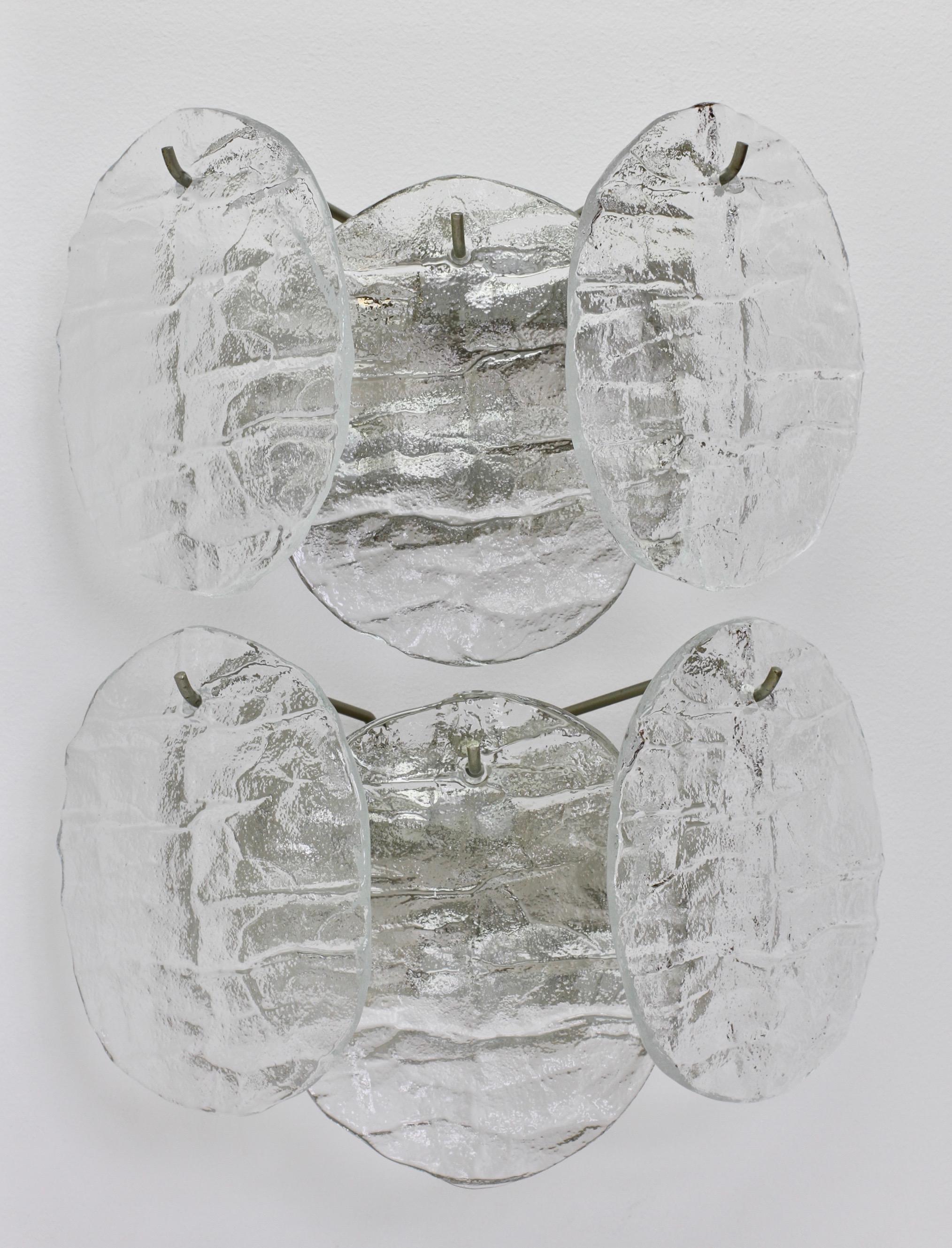 Paar alte Venini-Wandleuchter aus Österreich im Stil der Jahrhundertmitte von Kalmar, um 1965. Drei hängende Muranoglaselemente, die wie Scheiben aus schmelzenden Eiskristallen aussehen, hängen an einer nickelfarbenen, lackierten Halterung oder