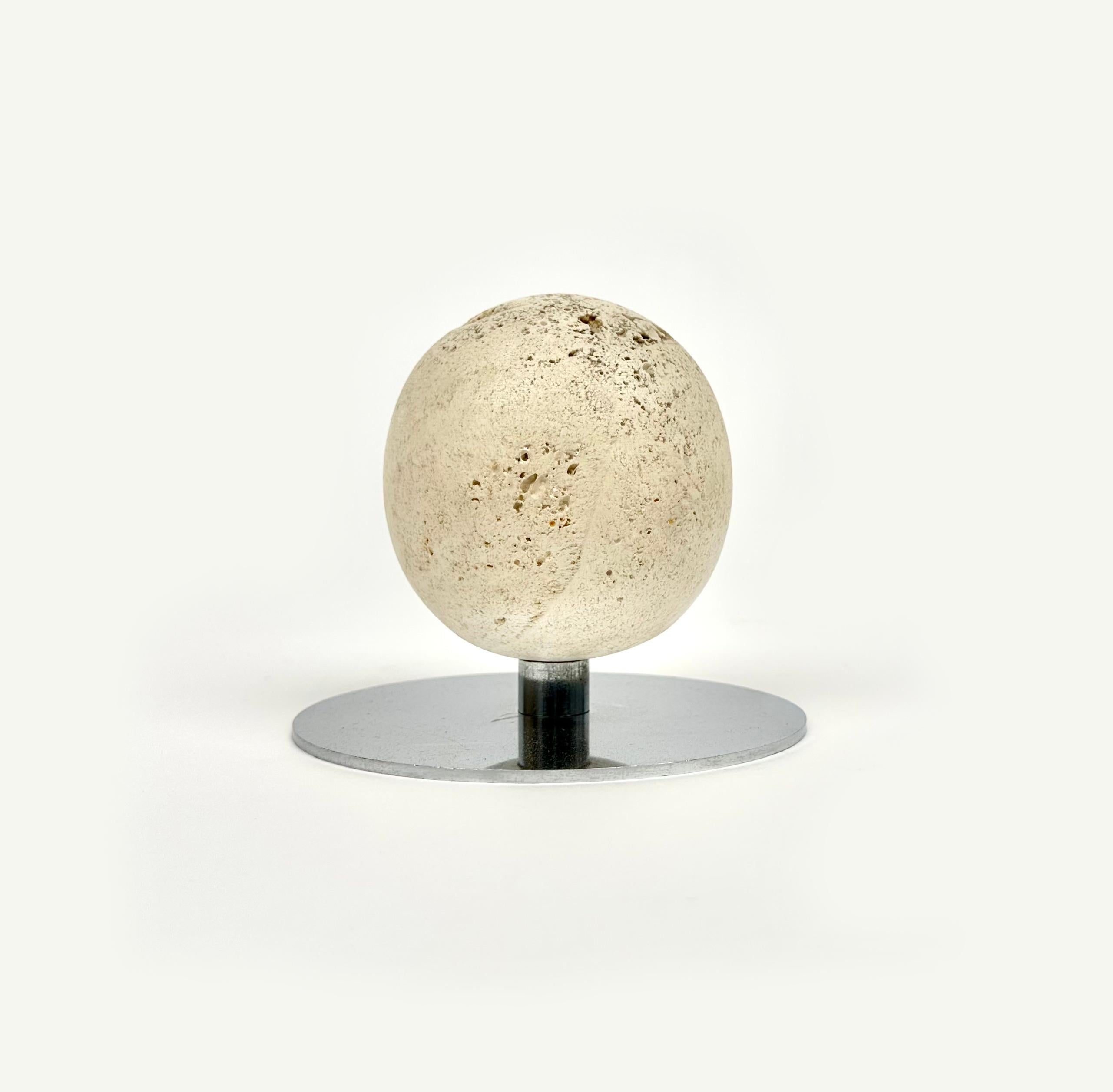 Midcentury sculpture / paperweight in steel and travertine in the shape of a ball in the style of Italian designer Enzo Mari.

Made in Italy in the 1970s.