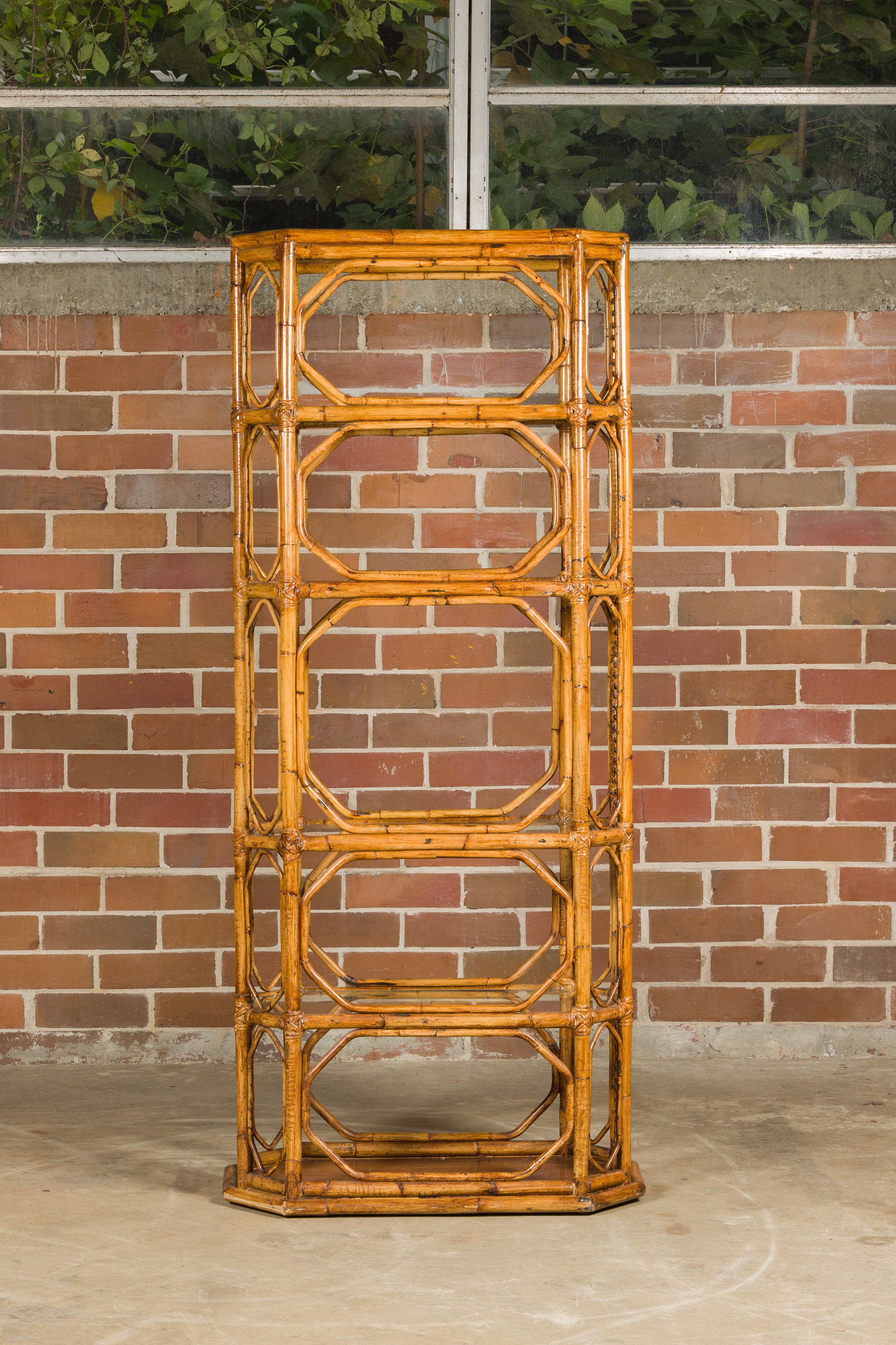 A Midcentury bamboo and glass étagère with five shelves and geometric accents. Step into the world of Midcentury elegance with this bamboo and glass étagère, a piece that beautifully combines natural materials with geometric precision. This étagère,