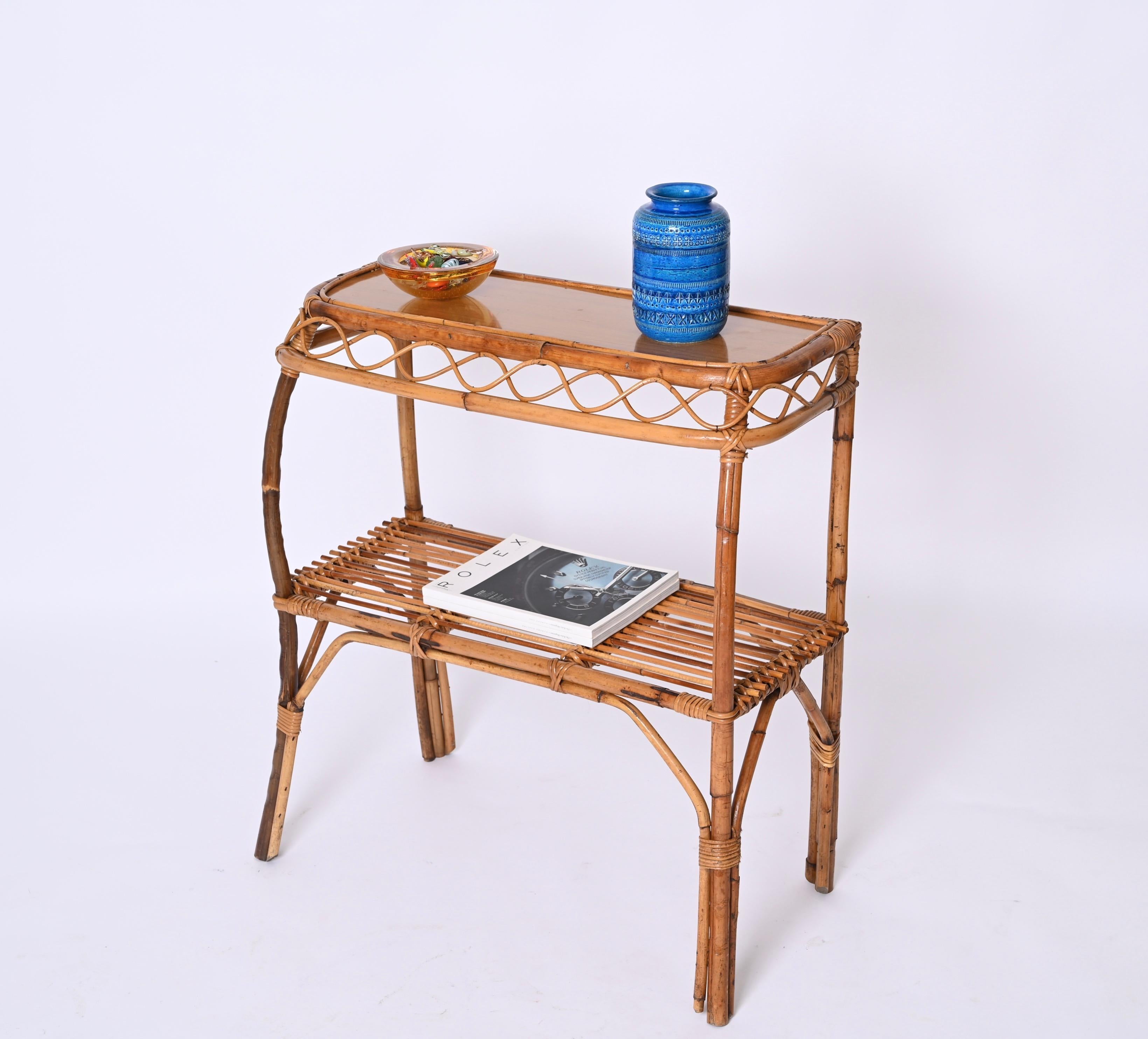 Stunning console table in bamboo and rattan. This amazing piece was produced in the style of Franco Albini in Italy during the 1960s.

Fully handmade, perfect example of Italian manufacture from the 60s. The console has four beautiful curved legs