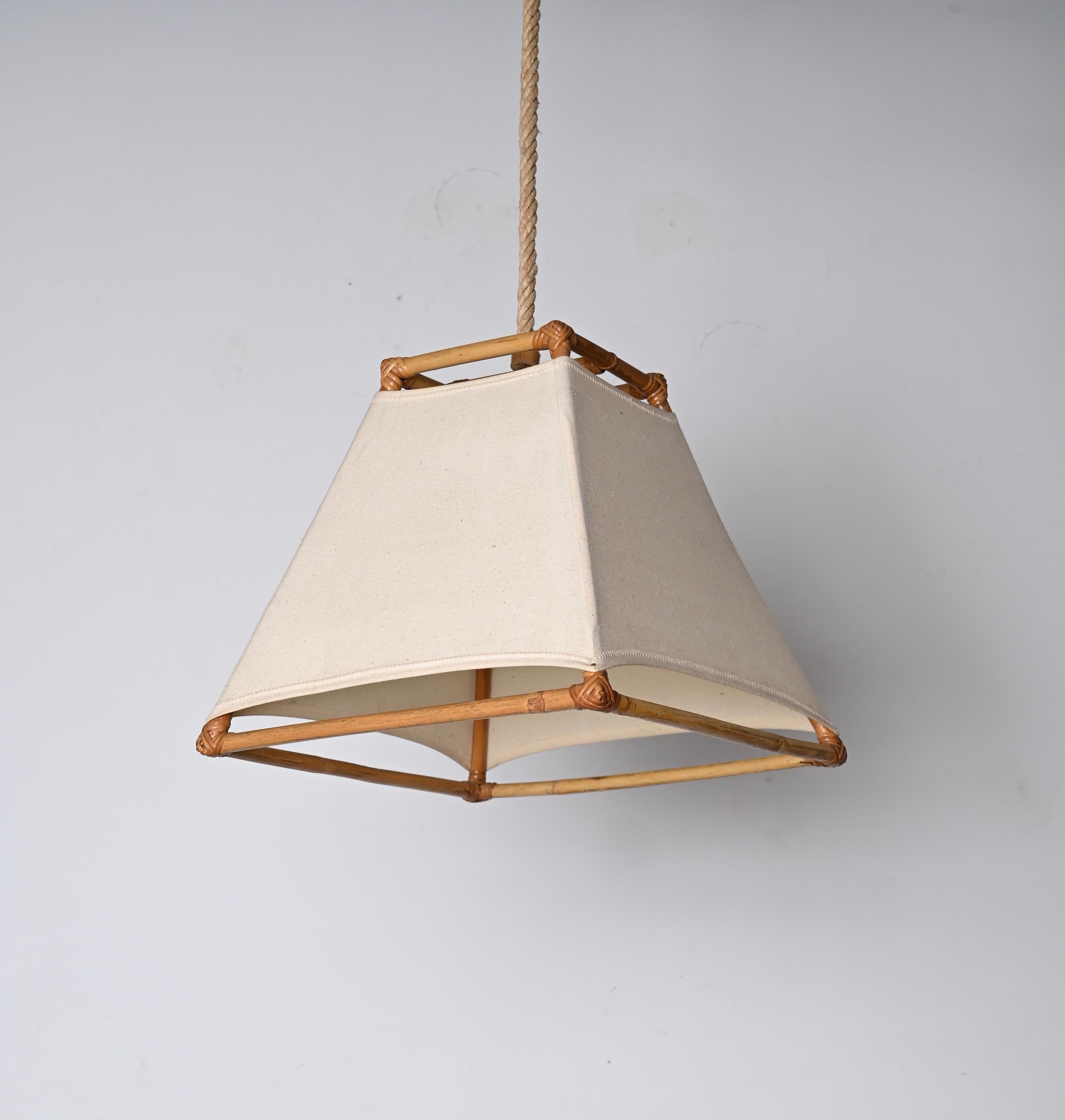 Stunning mid-century bamboo and rattan chandelier with white cream fabric and hemp rope. Louis Sognot probably designed this lovely piece in France during the 1960s.

This item is a crystalline example of midcentury French craftsmanship, with bamboo