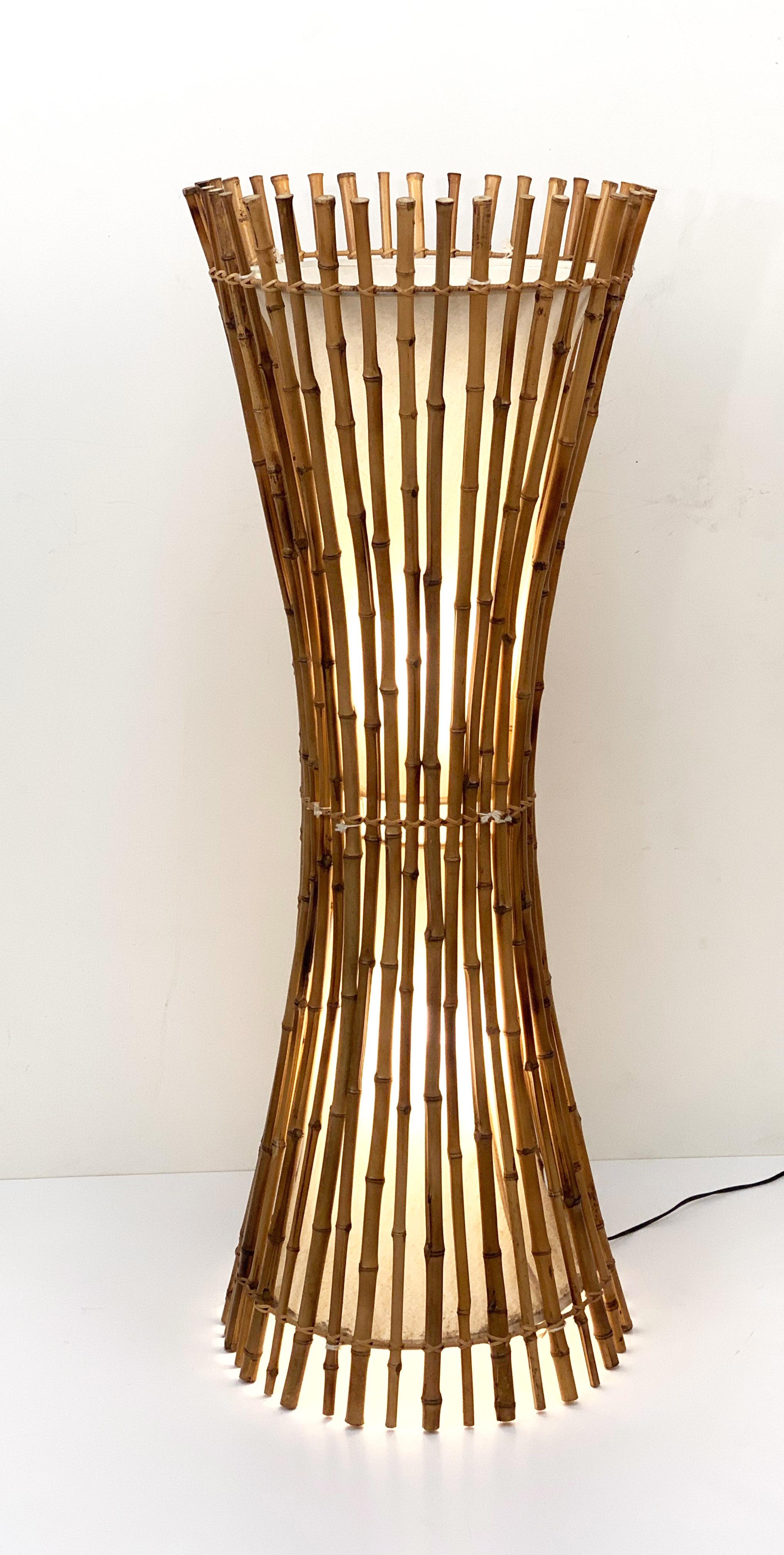 Wonderful midcentury floor lamp in the style of Franco Albini.

It is made of bamboo and rattan and it has the shape of two cones narrowing in the centre.

It is a marvellous piece produced in Italy during 1960s.

This item is perfect for a