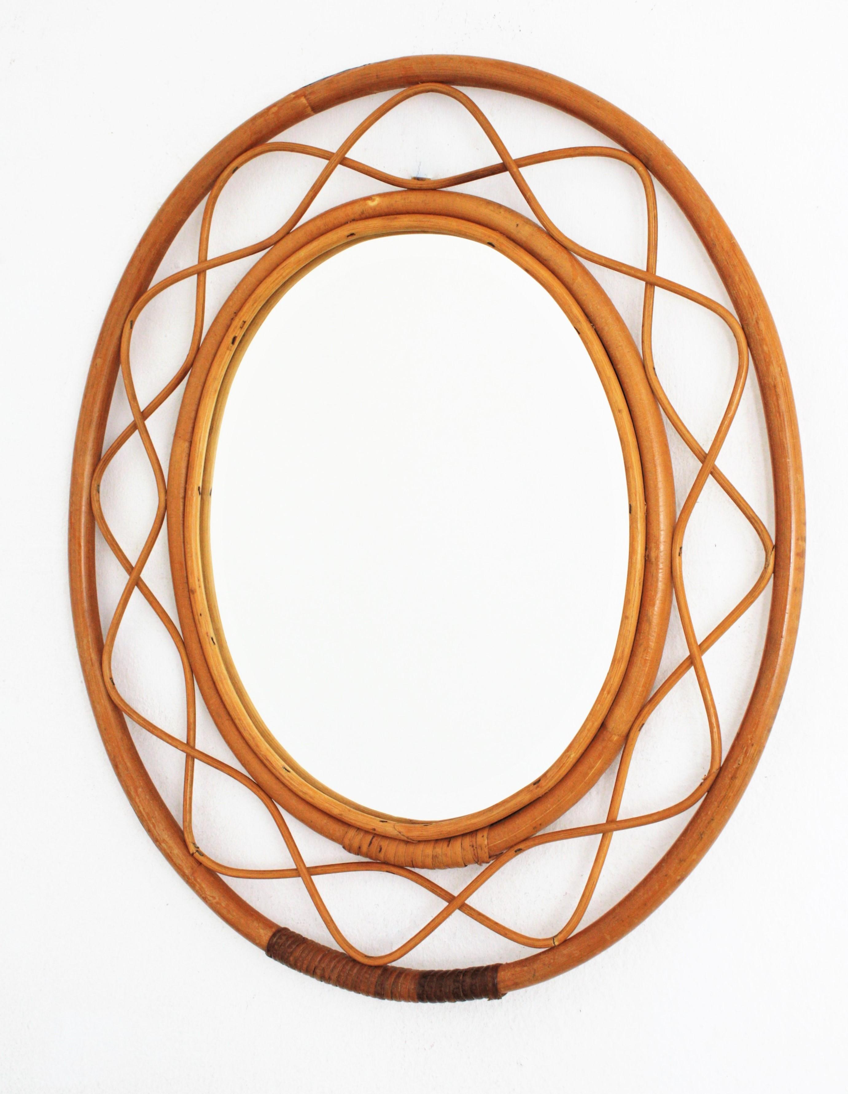 Lovely handcrafted bamboo and rattan oval mirror with all the taste of the Mediterranean coast style, France, 1960s.
Gorgeous to place it alone and also beautiful creating a wall decoration with other mirrors in this manner.
The frame has