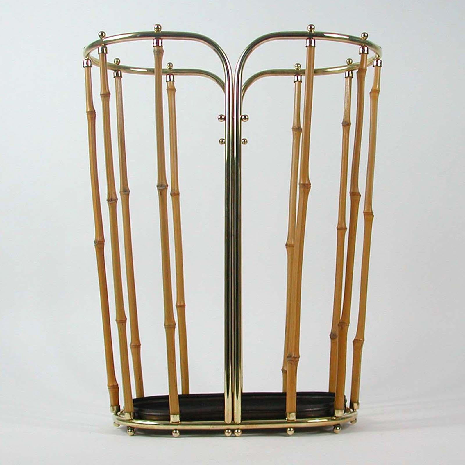 This beautiful oval umbrella stand was made in Austria in the 1950s. The exceptional design reminds of items by Carl Auböck, Hagenauer, Josef Frank or JT Kalmar. 

The stand is made of bamboo and brass and has got a removeable bronzed oval bowl to