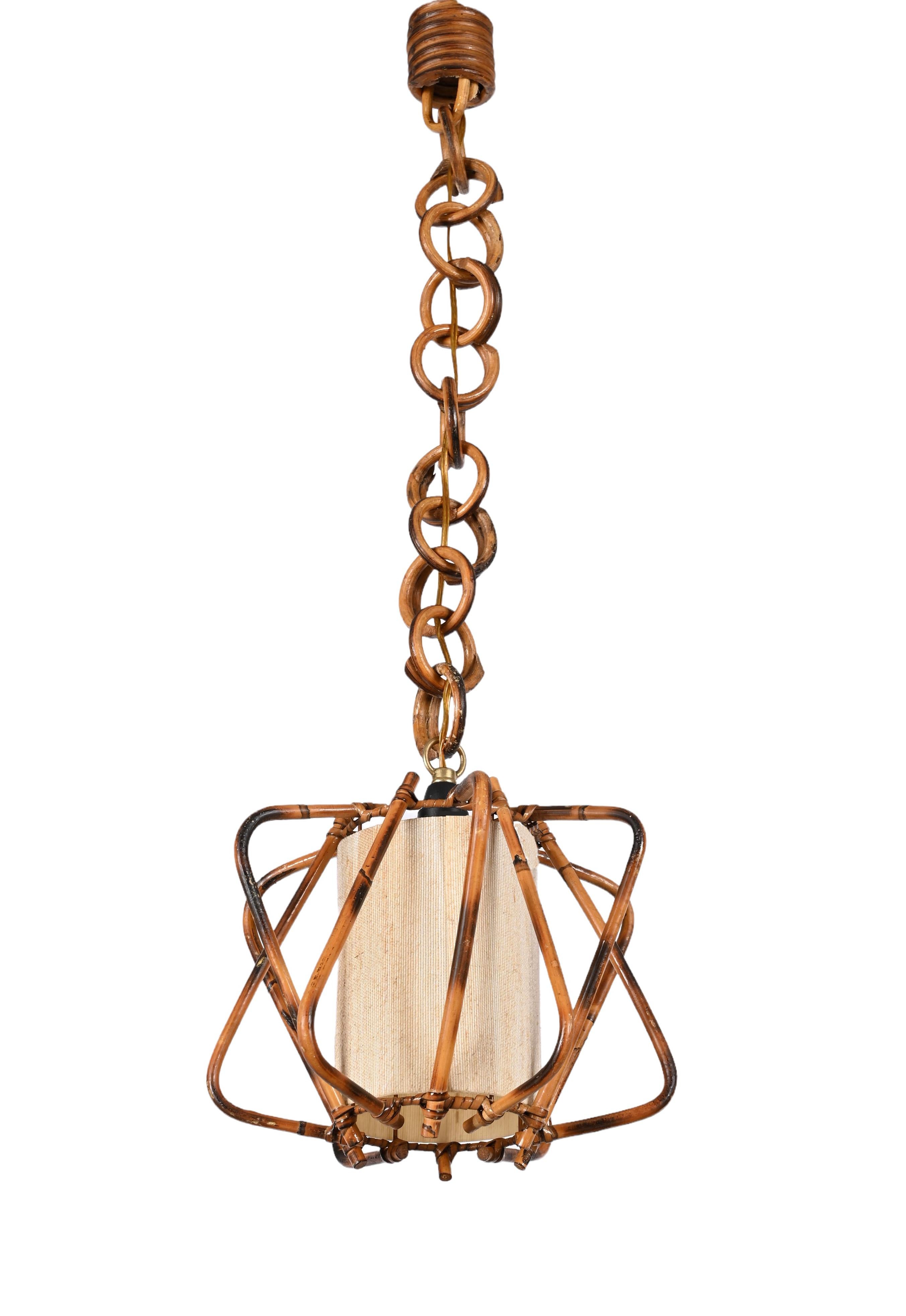 Fantastic midcentury bamboo and rattan chandelier with white cream fabric. Louis Sognot probably designed this extraordinary in France during the 1960s.

This item is a crystalline example of midcentury craftsmanship, with bamboo and rattan