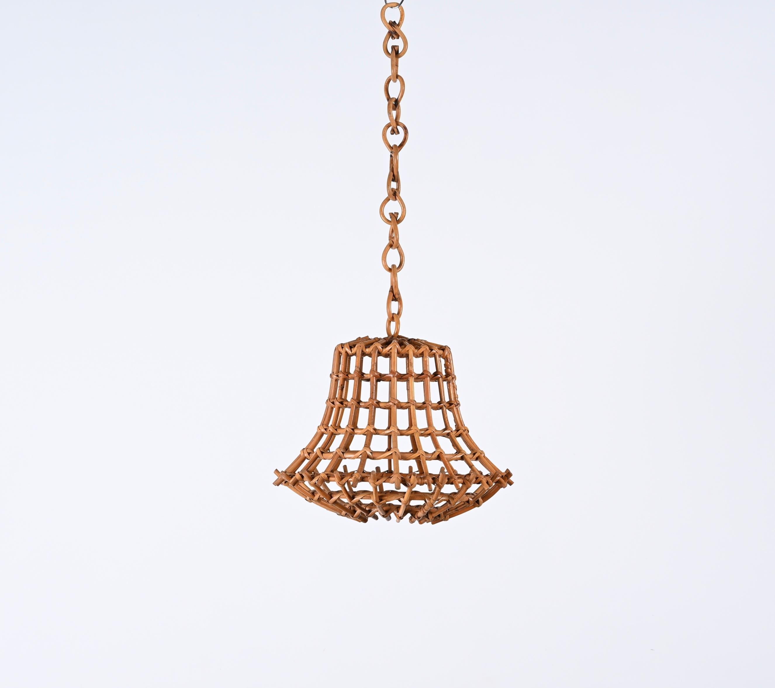 Stunning midcentury bamboo and rattan chandelier. This astonishing piece was produced in France during the 1960s and it is attributed to Louis Sognot.

A wonderful example of midcentury artisanal work, where bamboo and rattan are perfectly blended