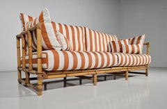Midcentury Bamboo indoor/outdoor sofa with orange/cream fabric, France, 1960s