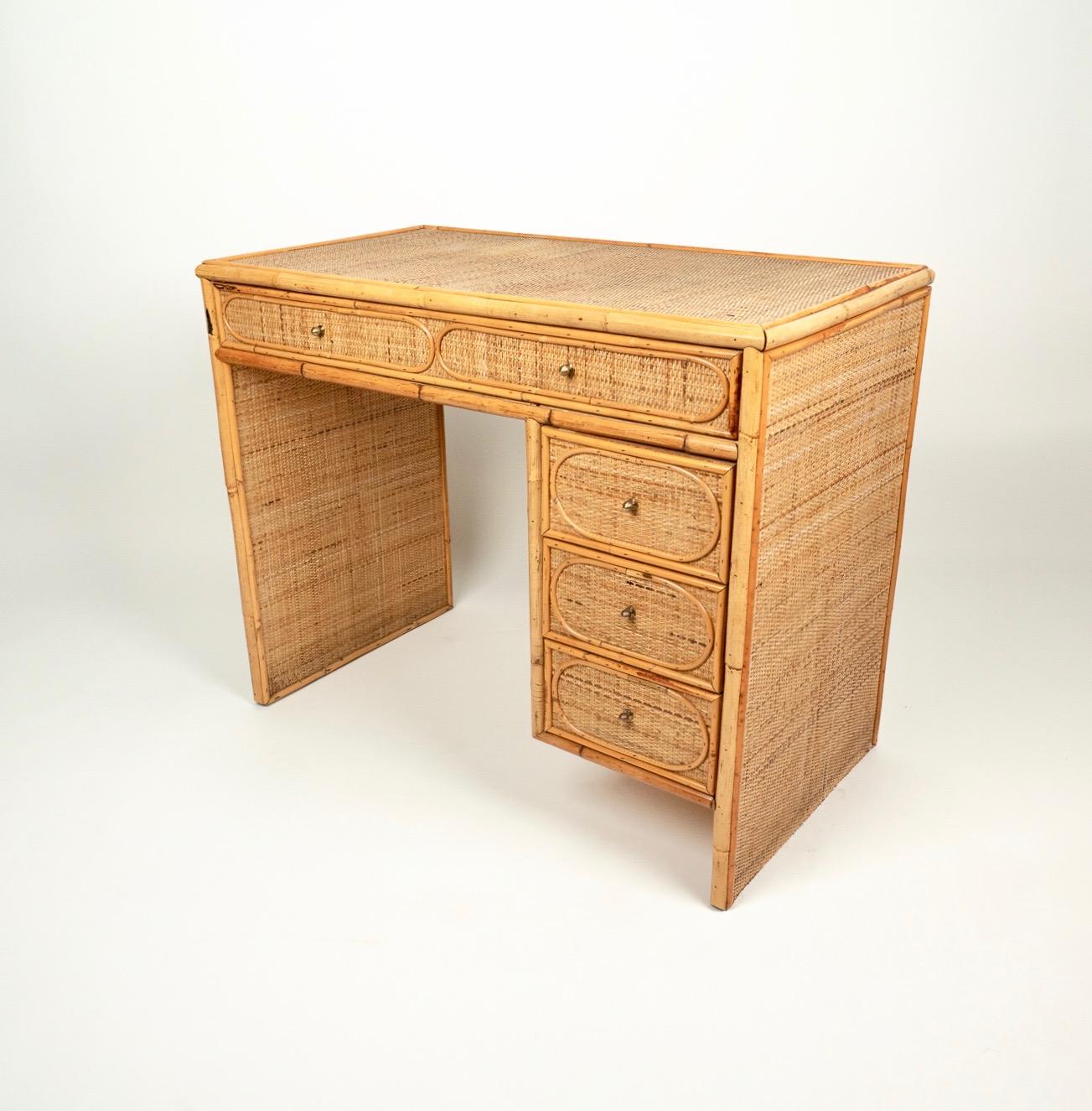 Writing table / desk in rattan, bamboo and wood featuring four drawers.

Made in Italy in the 1970s.