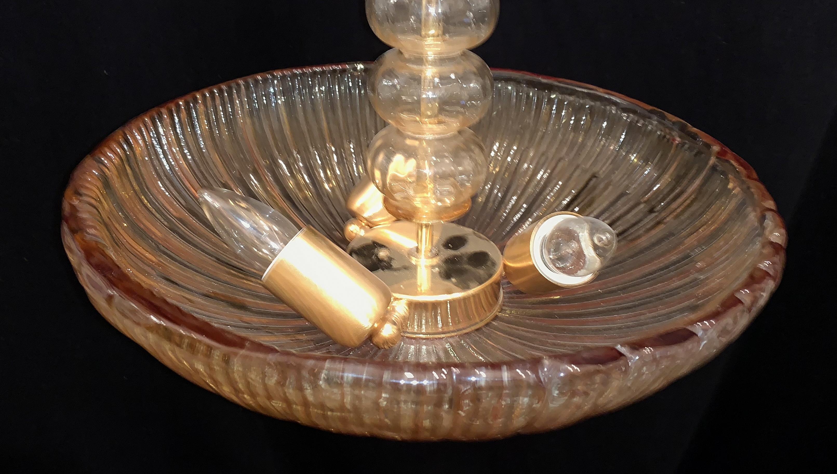 A wonderful midcentury Barovier Toso Seguso style Murano Italian ribbed amber glass dome light fixture chandelier with 3 Edison lights inside.
Completely rewired and ready to enjoy with all mounting hardware and canopy.
Height can be adjustable