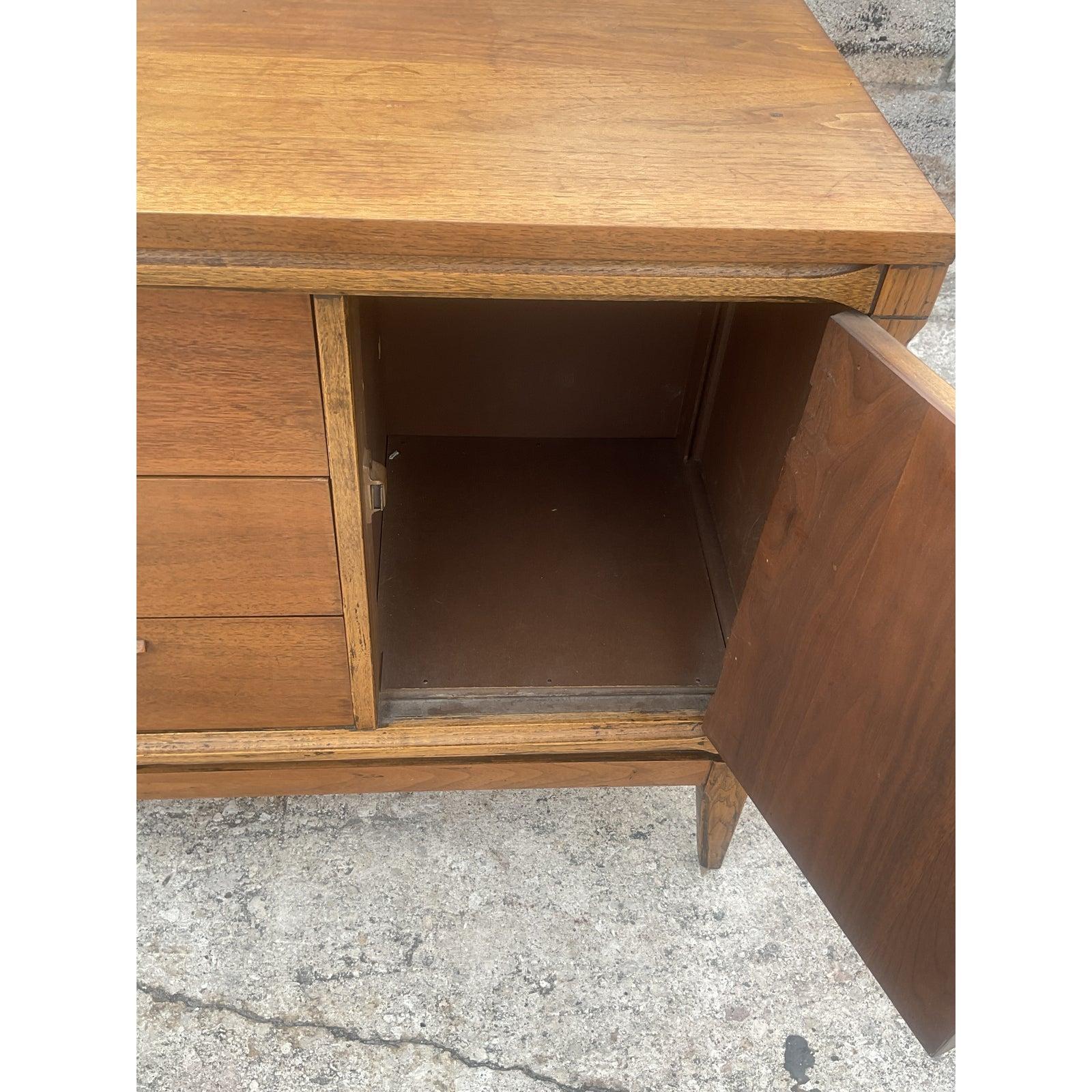Gorgeous vintage midcentury sideboard. Beautiful Bassett cabinet with beautiful parquet wood detail. Chic variations in wood really make this cabinet a standout. Acquired from a Palm Beach estate.