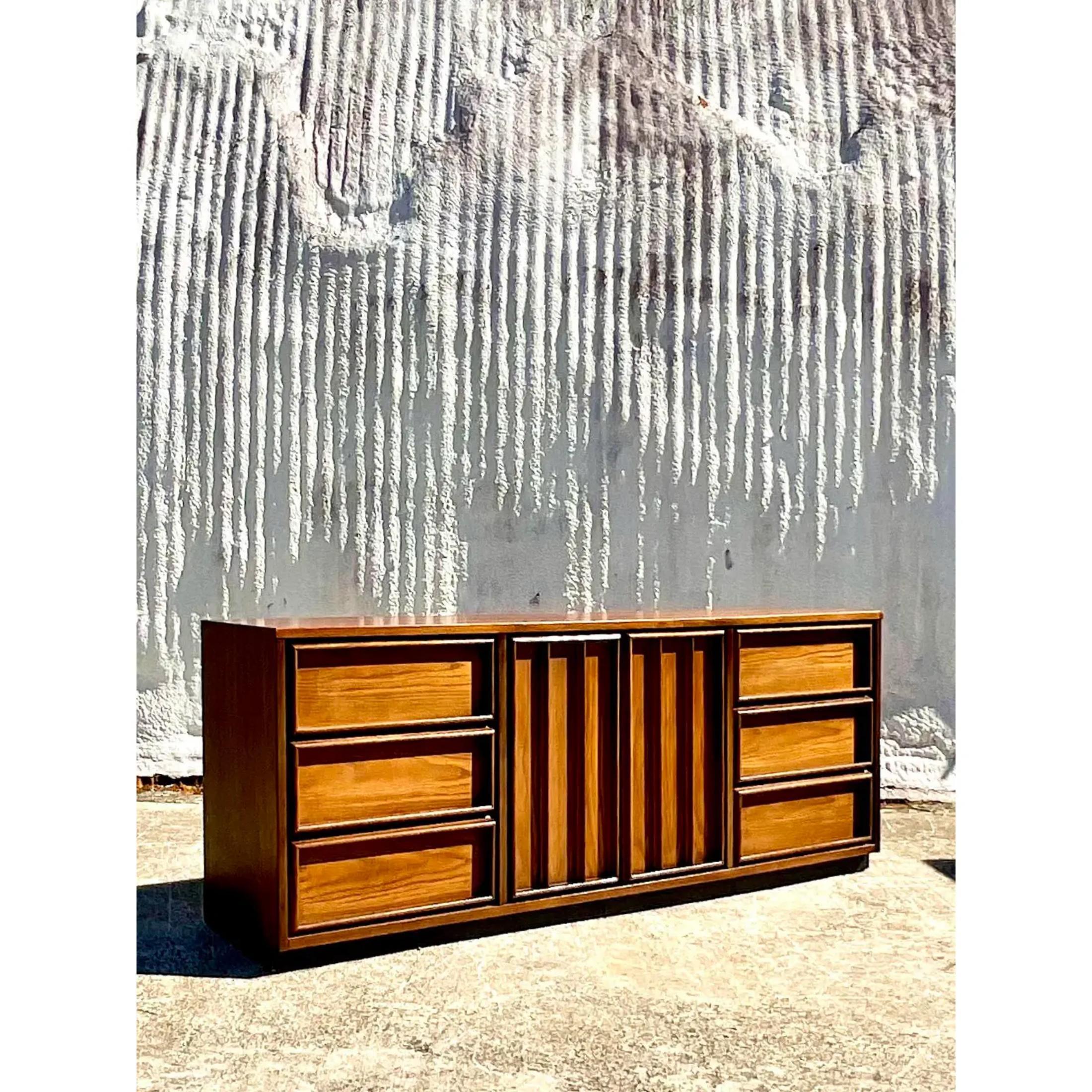 Outstanding MidCentury Bassett 9 drawer dresser. A chic combination of walnut and oak. Two doors open to reveal three additional drawers. Marked inside the top drawer. Acquired from a Palm Beach estate