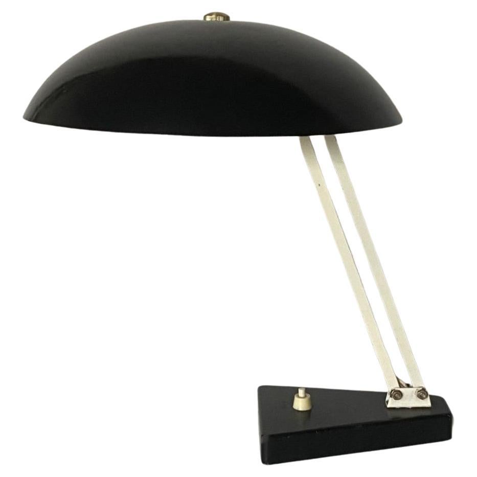 Bauhaus desk or table lamp in steel with black enameled metal shade (inside white), from the 1950s. This desk lamp is adjustable in height and angle, beautiful, minimalistic design and in very good vintage condition, with original pressure switch on